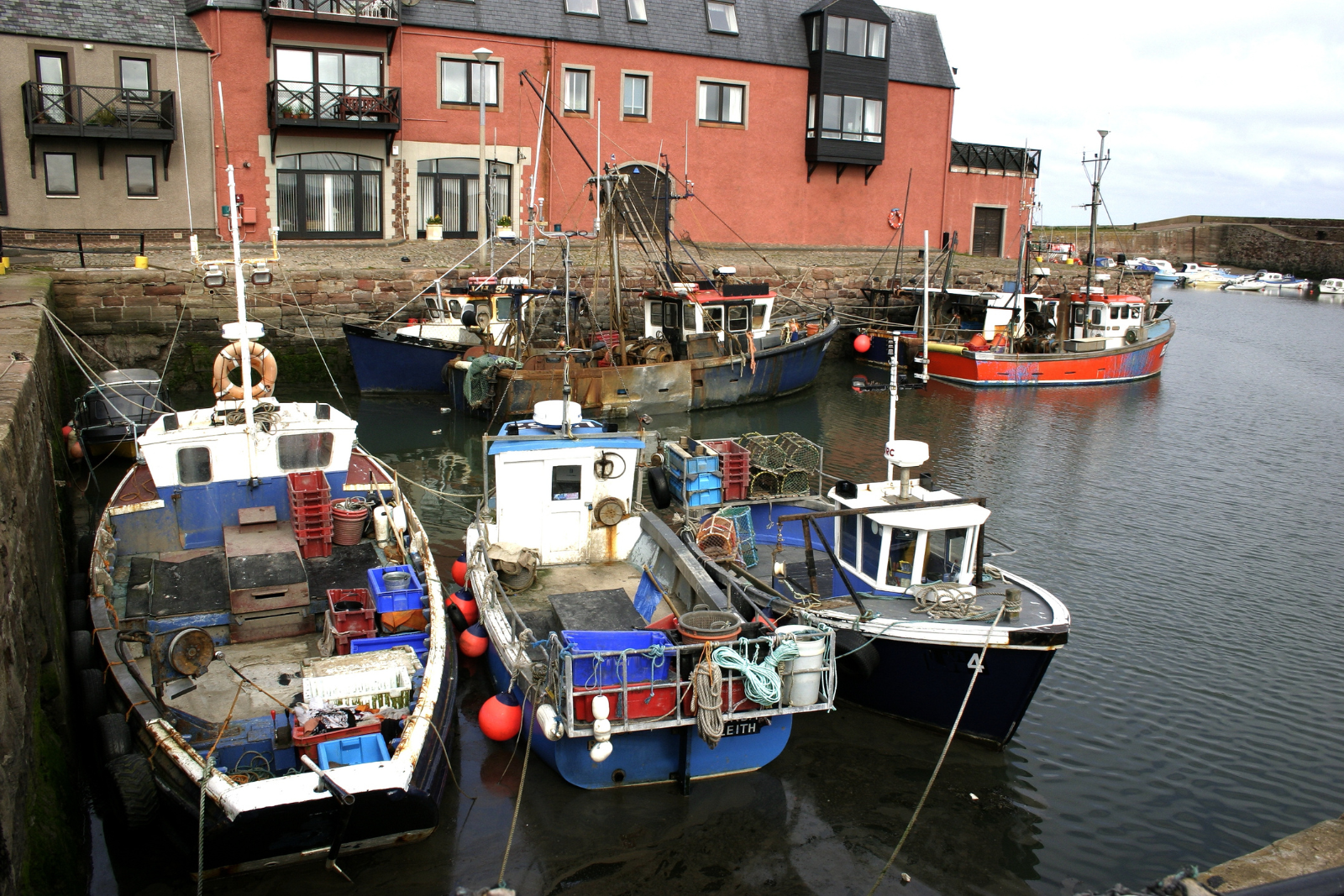 Fishing boats moored in Dunbar harbour at the eastern end of the John Muir Way.