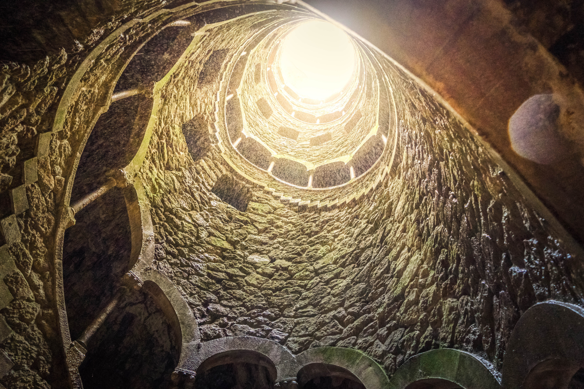 Spiral stone staircase inside the Initiation Well at Quinta da Regaleira, Sintra.