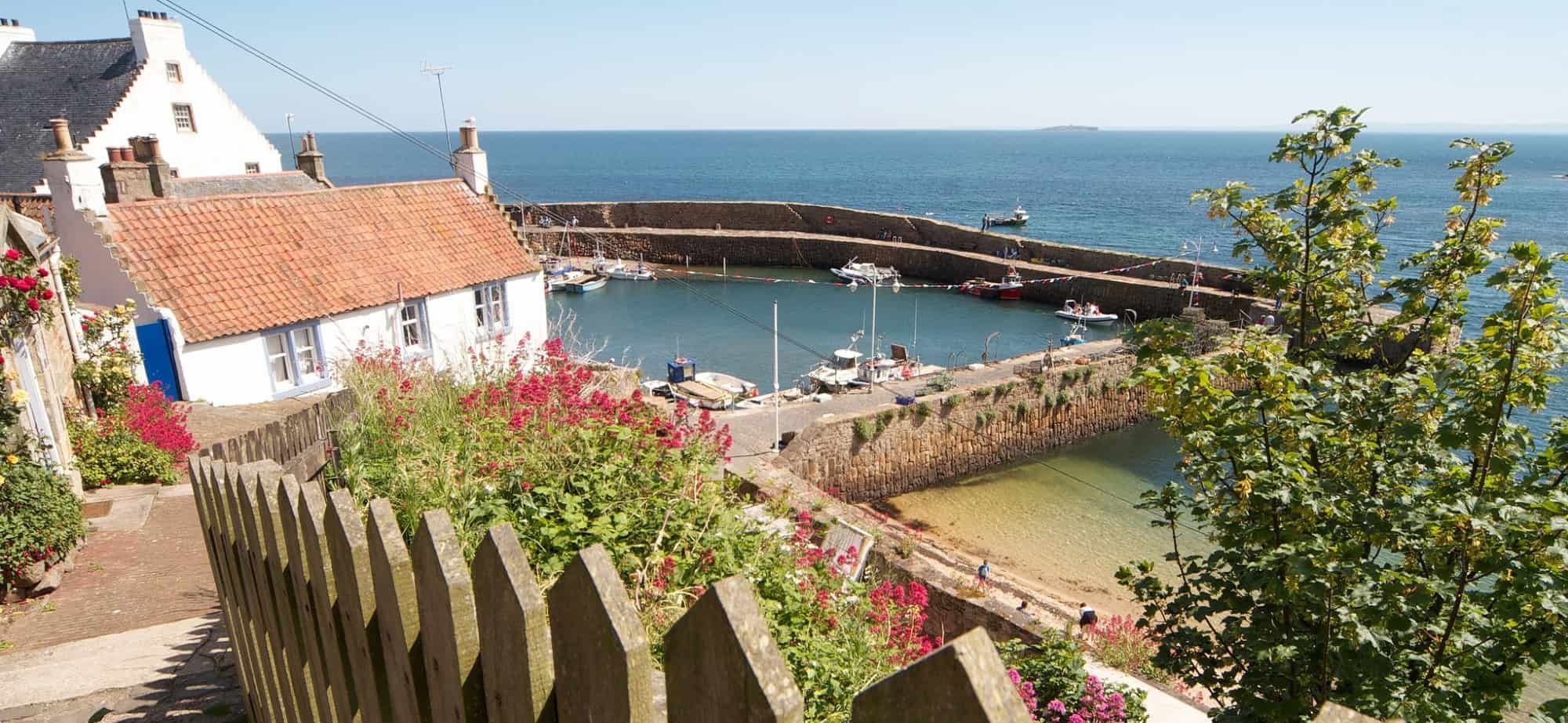 Harbour and whitewashed cottages along the Fife Coast Path in Scotland.