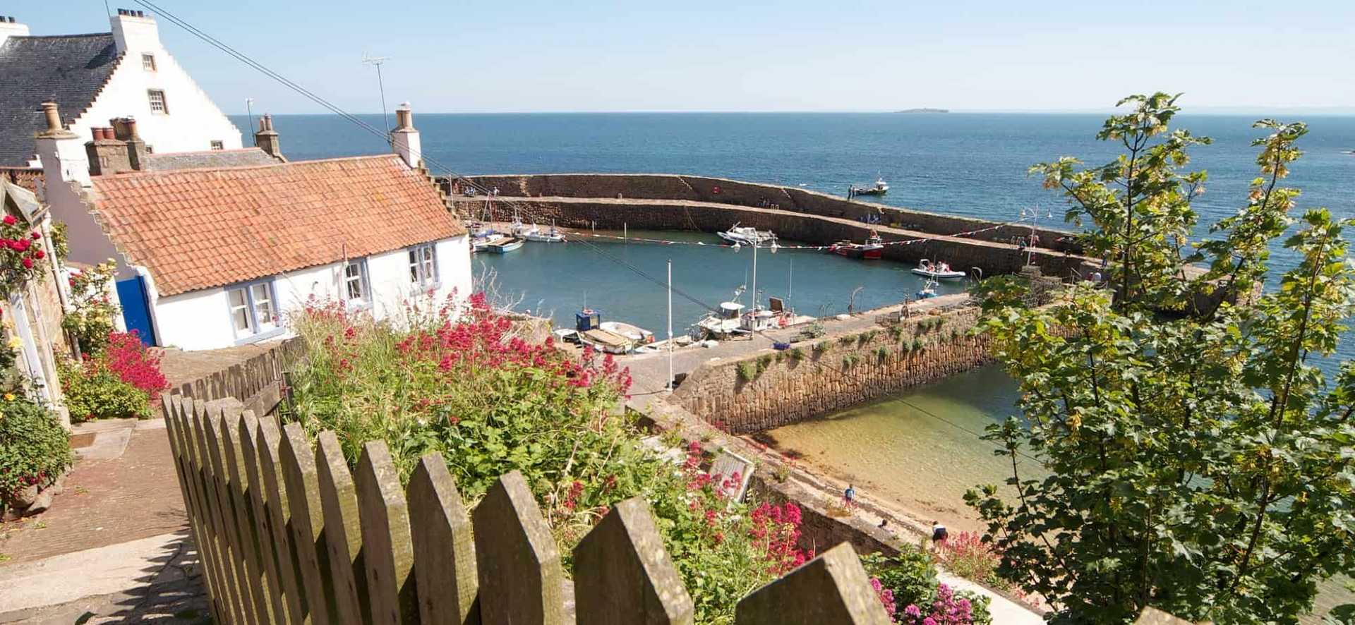 Harbour and whitewashed cottages along the Fife Coast Path in Scotland.
