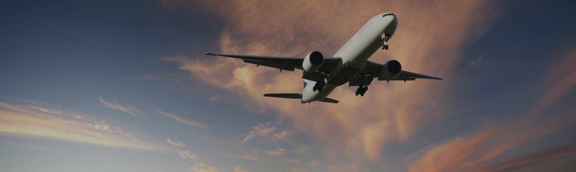 A large passenger jet aeroplane flying low overhead.