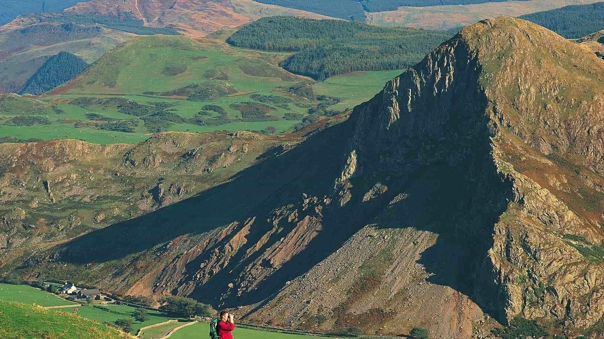 Man at mountains with binoculars