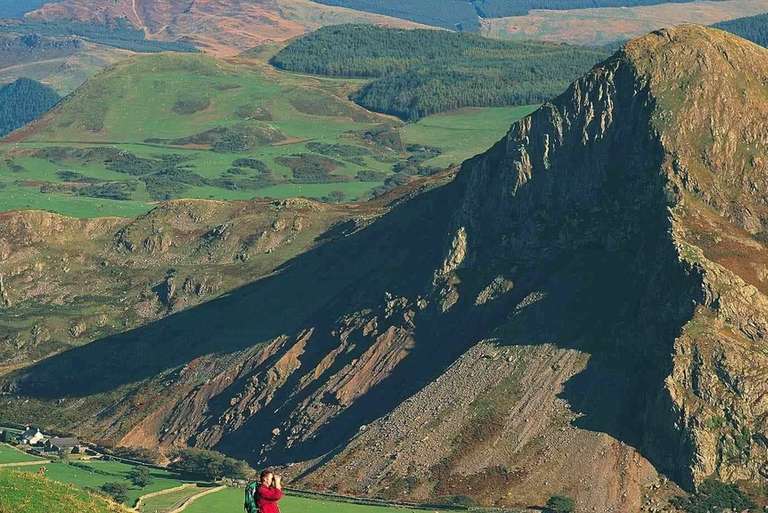 Man at mountains with binoculars