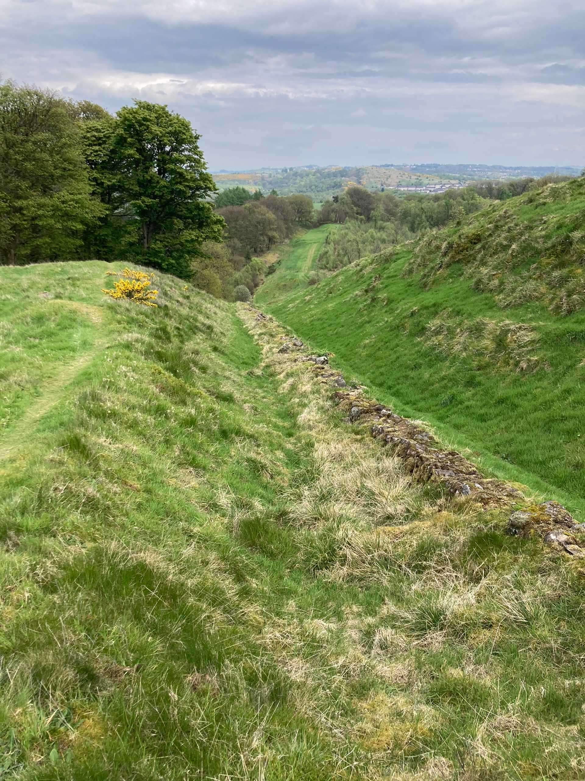 Grassy ditch and earthworks of the Antonine Wall beside the John Muir Way.