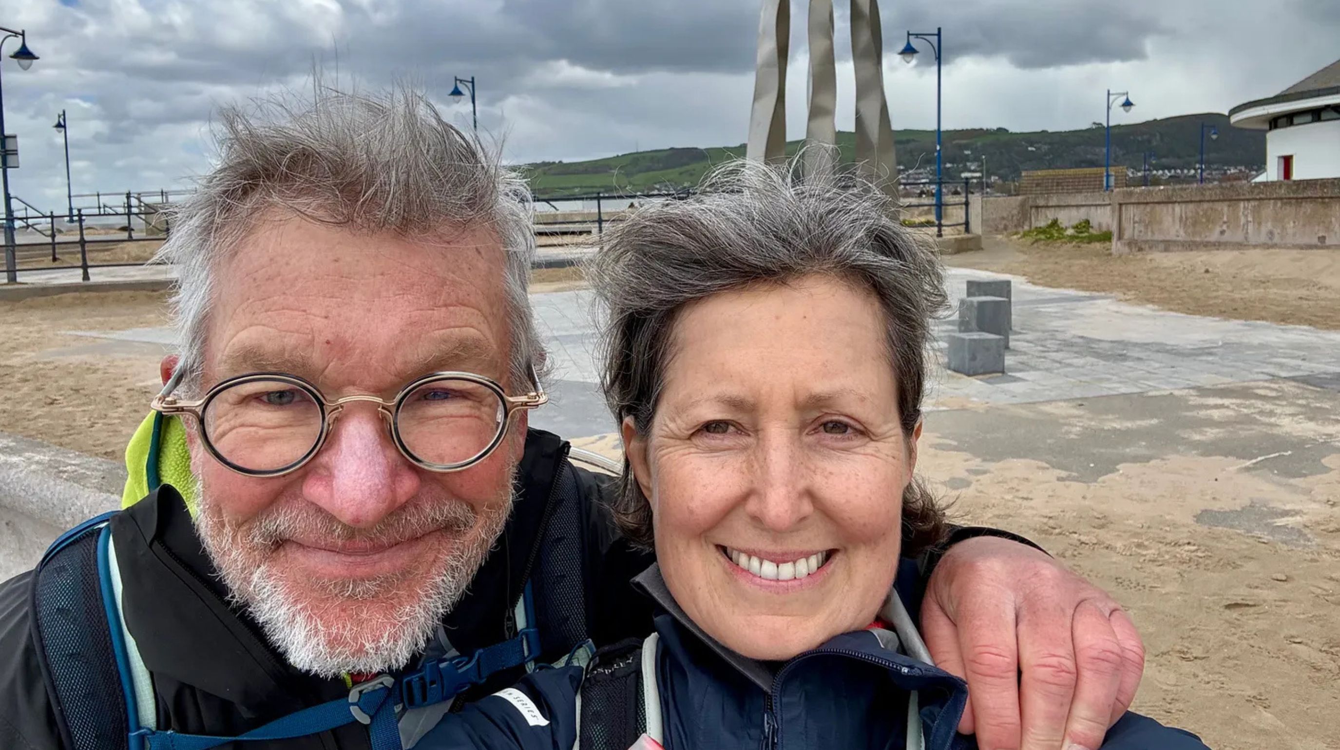Two walkers at the finish of the Offa's Dyke Path in Prestatyn