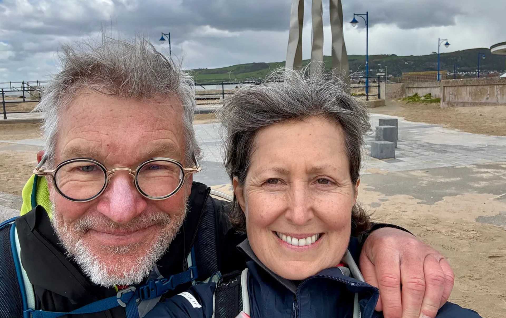 Two walkers at the finish of the Offa's Dyke Path in Prestatyn