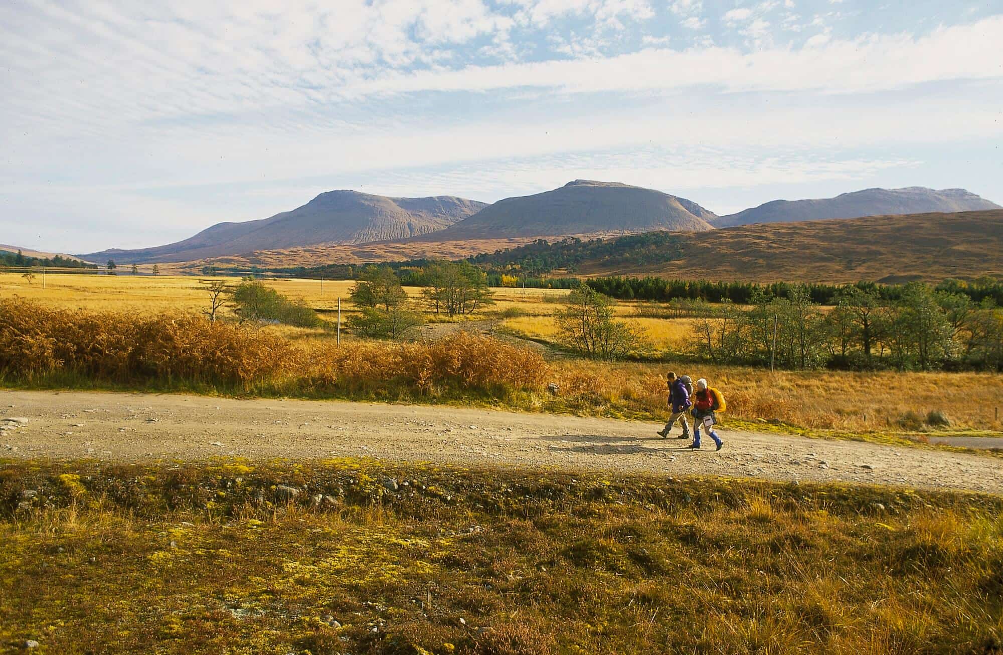 Walkers crossing open moorland on the West Highland Way in the Scottish Highlands