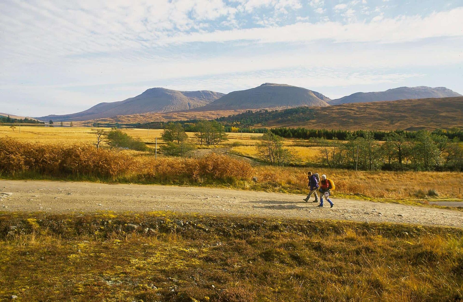 Walkers crossing open moorland on the West Highland Way in the Scottish Highlands