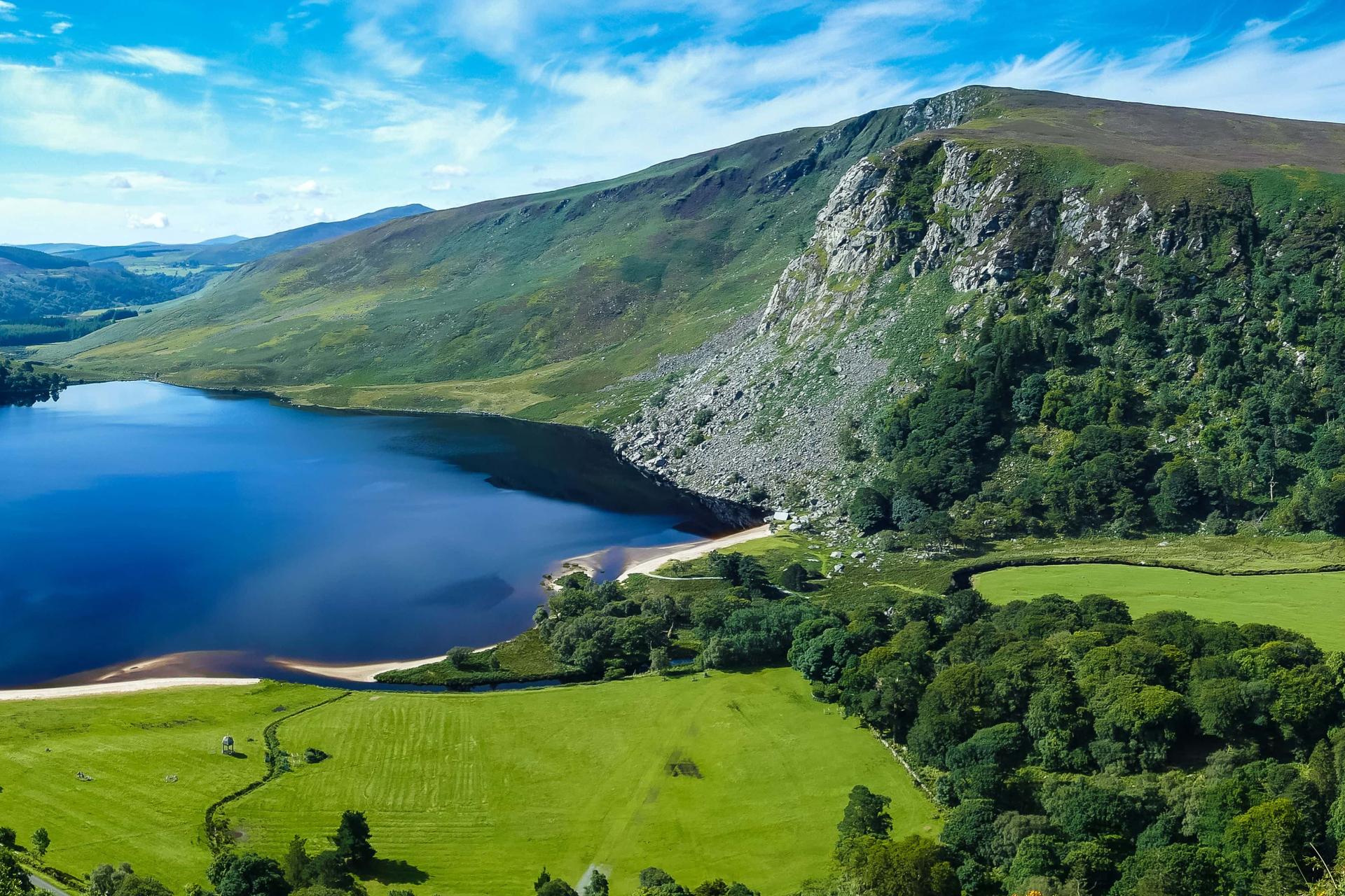 View across Upper Lake at Glendalough, surrounded by wooded hills