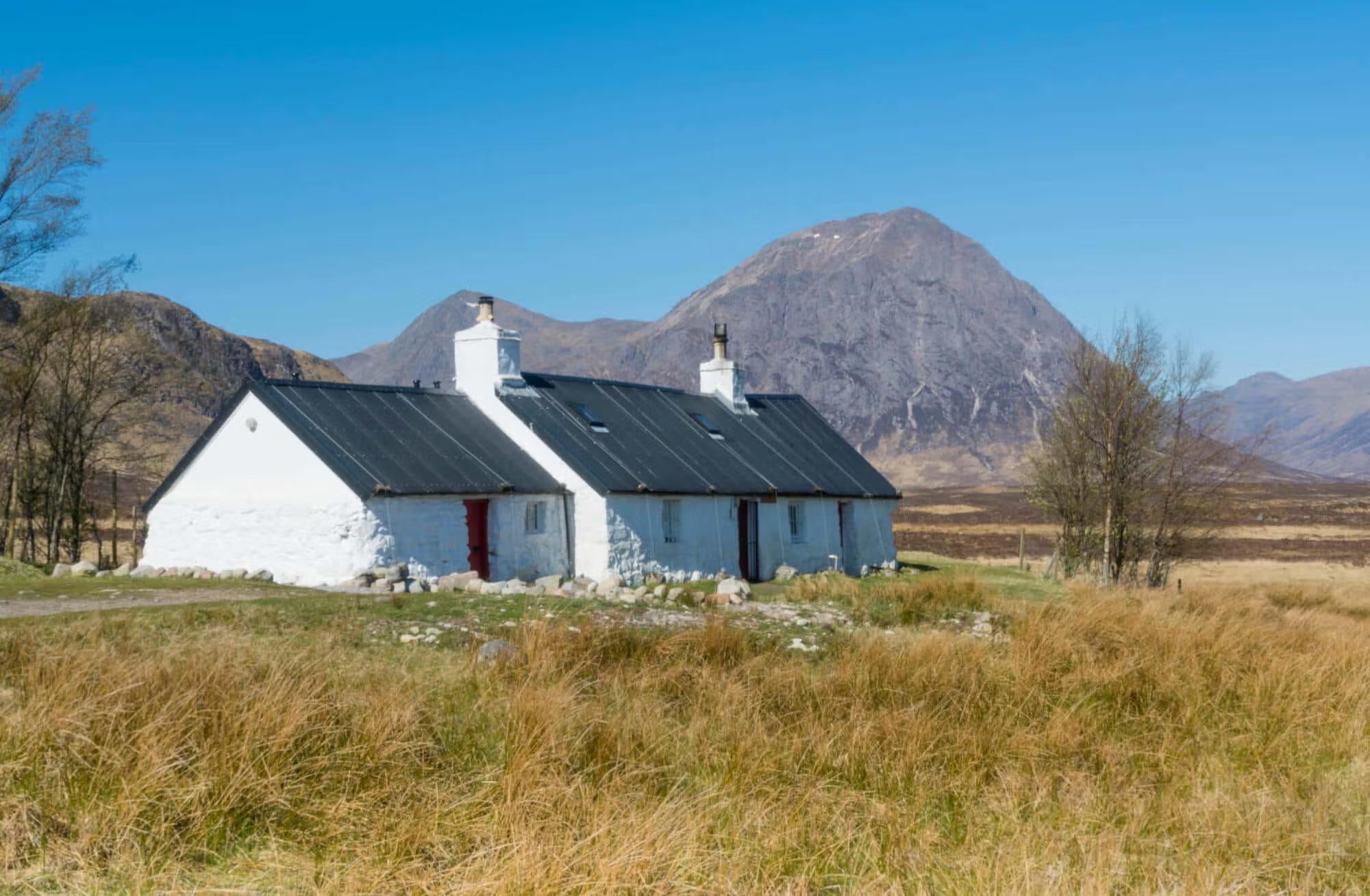 Whitewashed Highland cottage at Blackrock beneath Buachaille Etive Mòr on the West Highland Way.