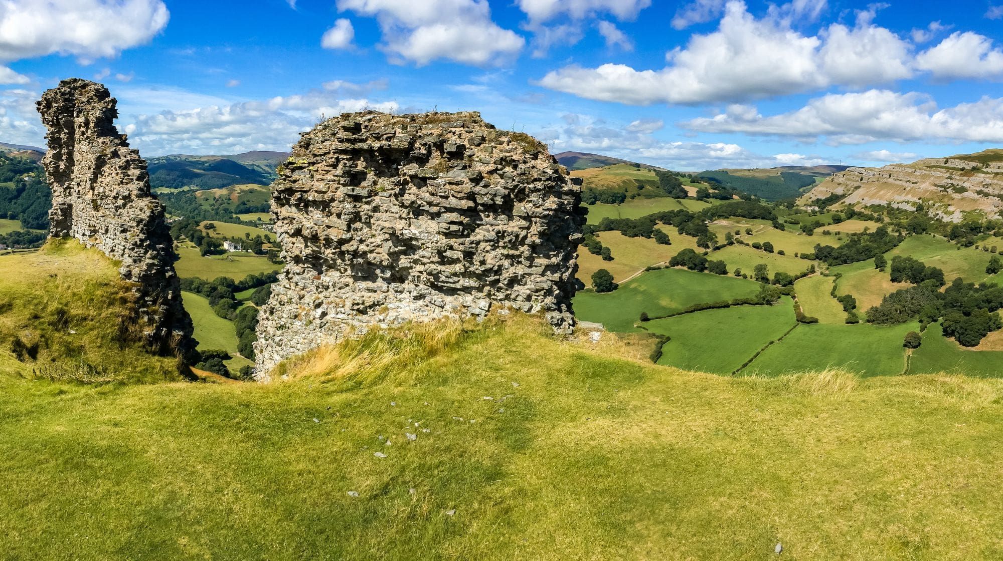 Hilltop castle ruins and rolling Welsh countryside along Offa’s Dyke Path.