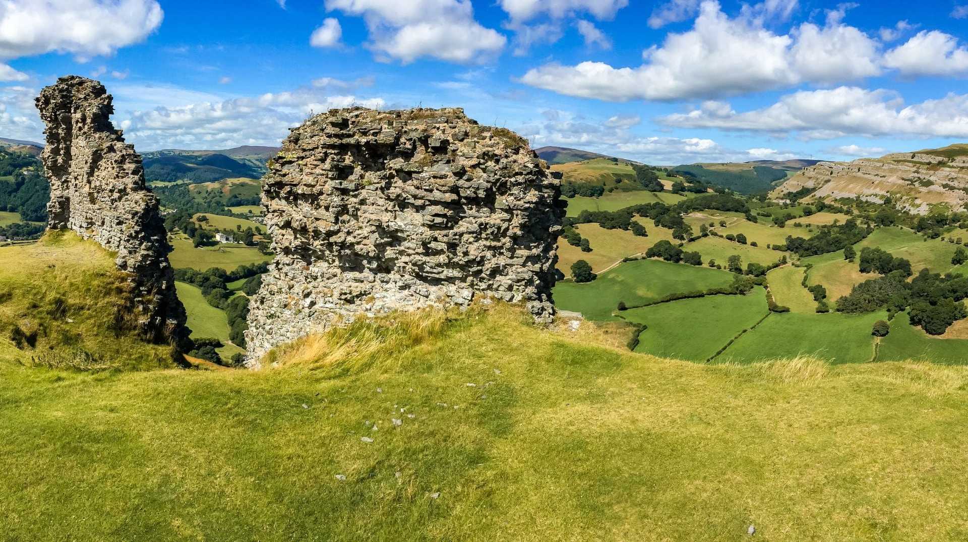 Hilltop castle ruins and rolling Welsh countryside along Offa’s Dyke Path.