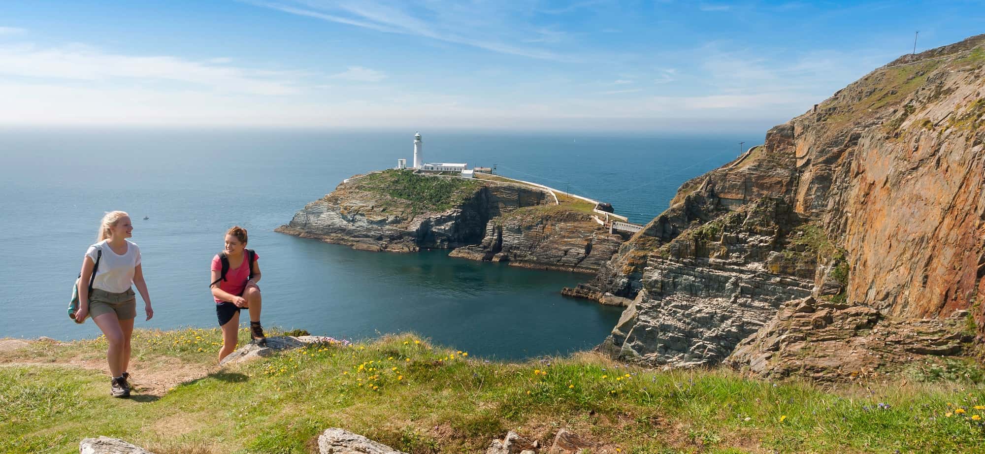Smiling walkers on the Anglesey Coast Path