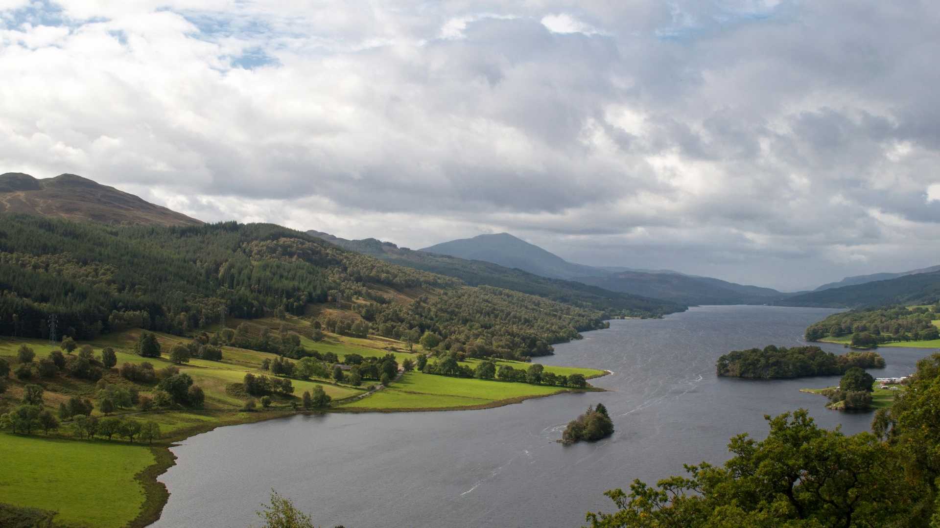 View over Loch Tummel from Queen’s View, with wooded hills and small islands in Highland Perthshire.
