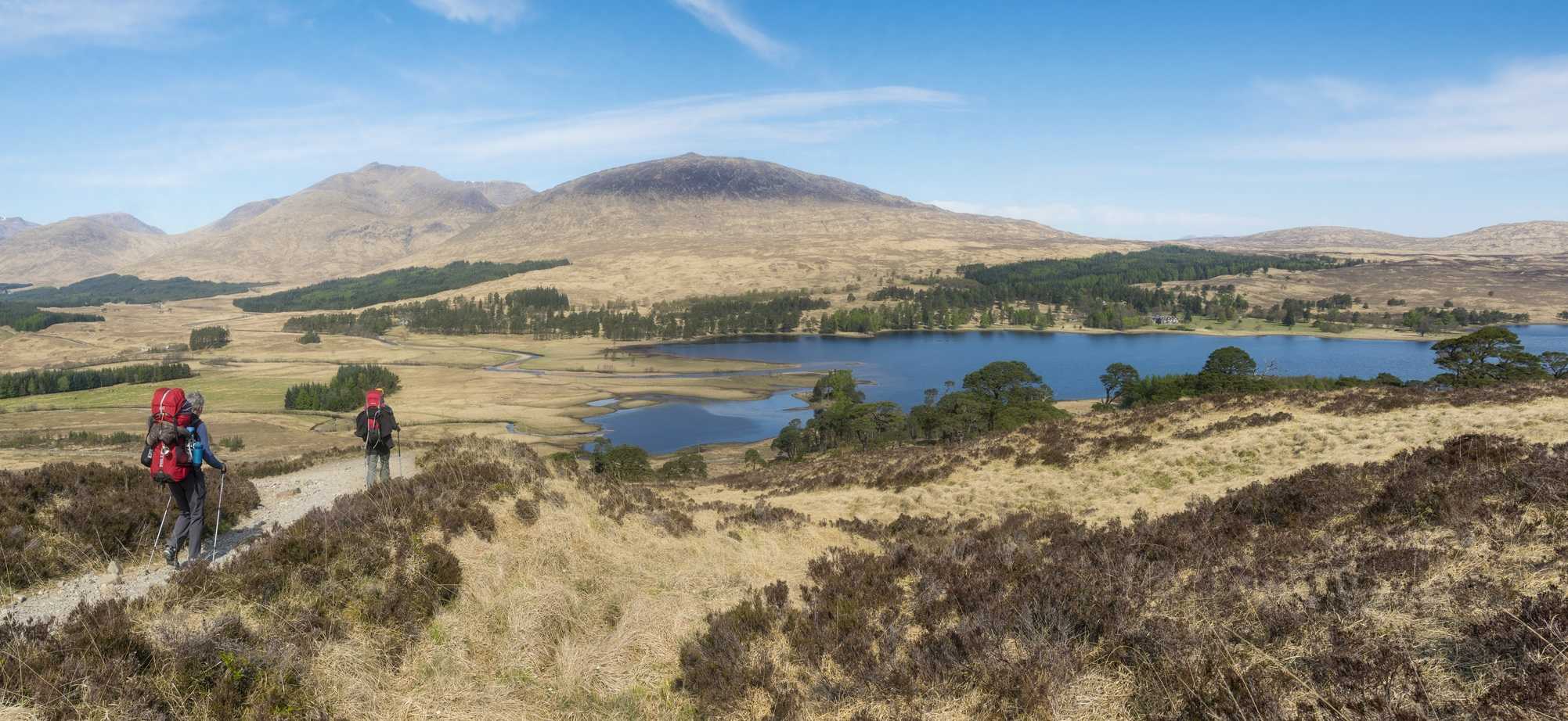 Walkers on the West Highland Way between Bridge of Orchy and Glencoe with Loch Tulla seen beyond