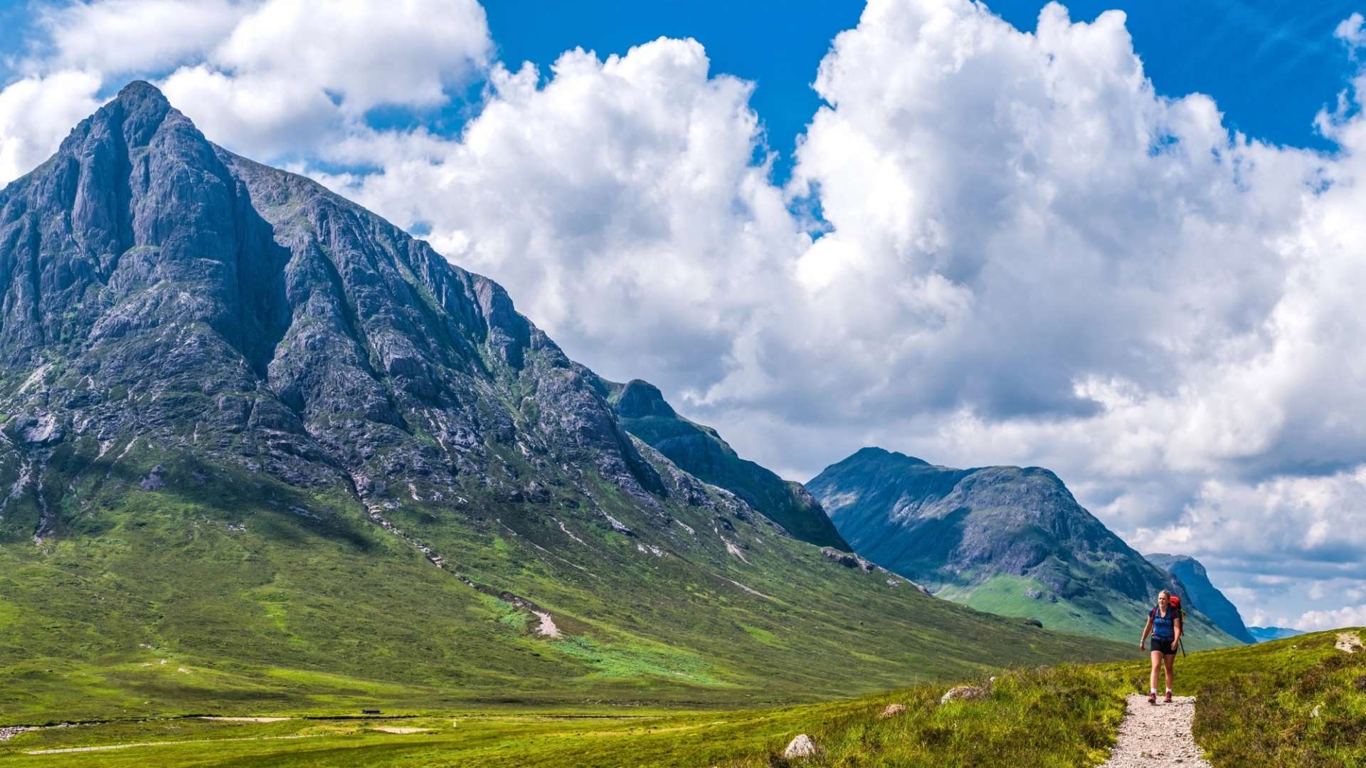 Hiker walking through dramatic mountain scenery in the Scottish Highlands on a self-guided walking holiday