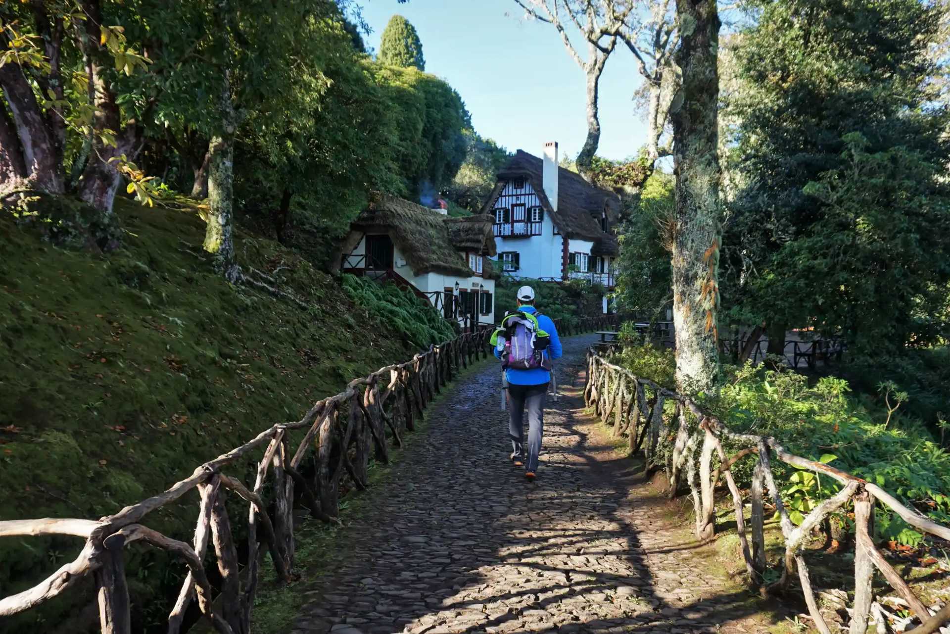 Walker approaching a traditional Madeiran house at Queimadas Park