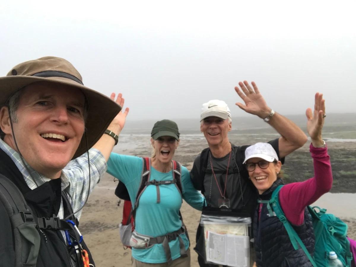 Walkers celebrating the end of the Coast to Coast Walk at Robin Hood’s Bay