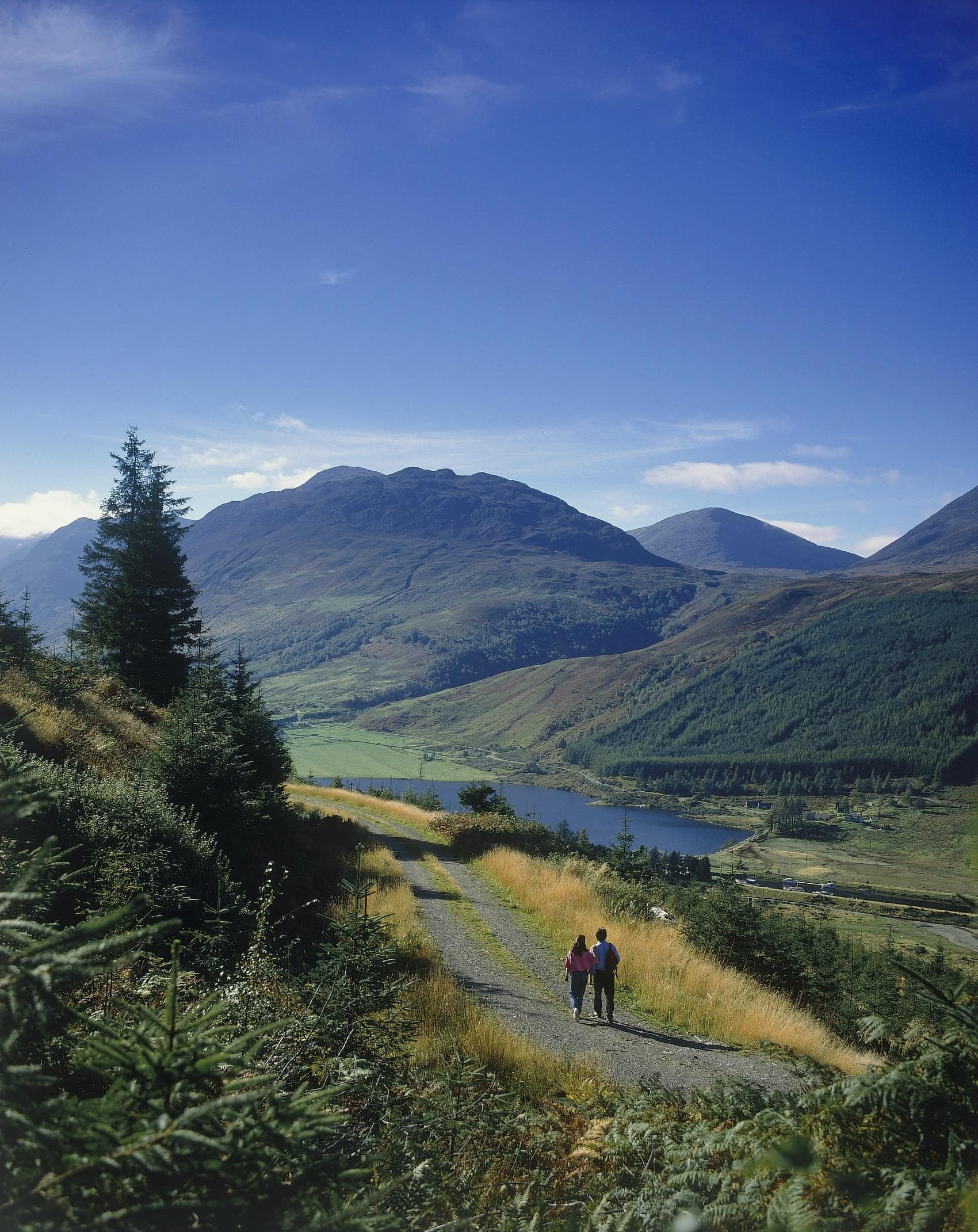 Image of couple walking by loch along the great glen way