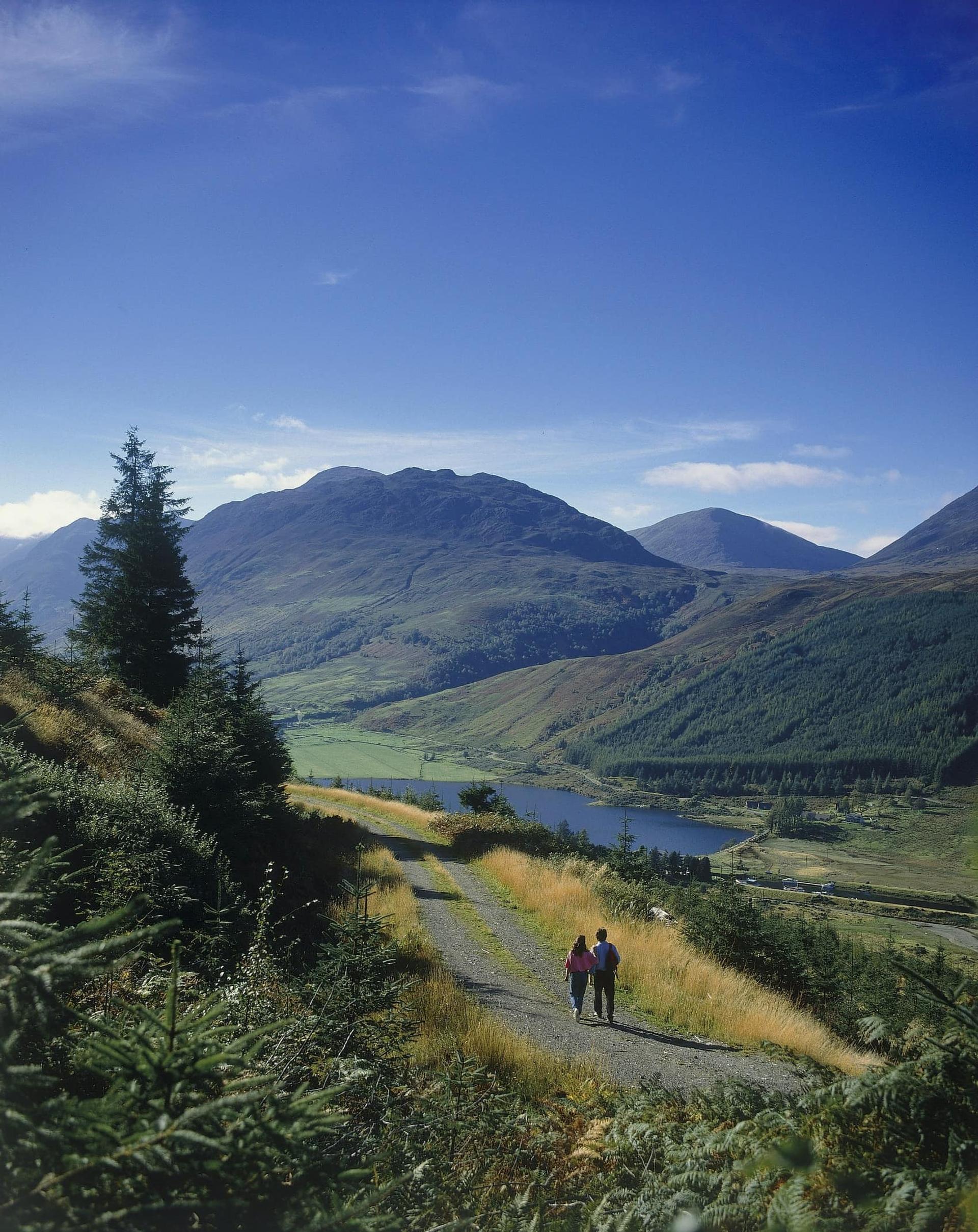 Image of couple walking by loch along the great glen way