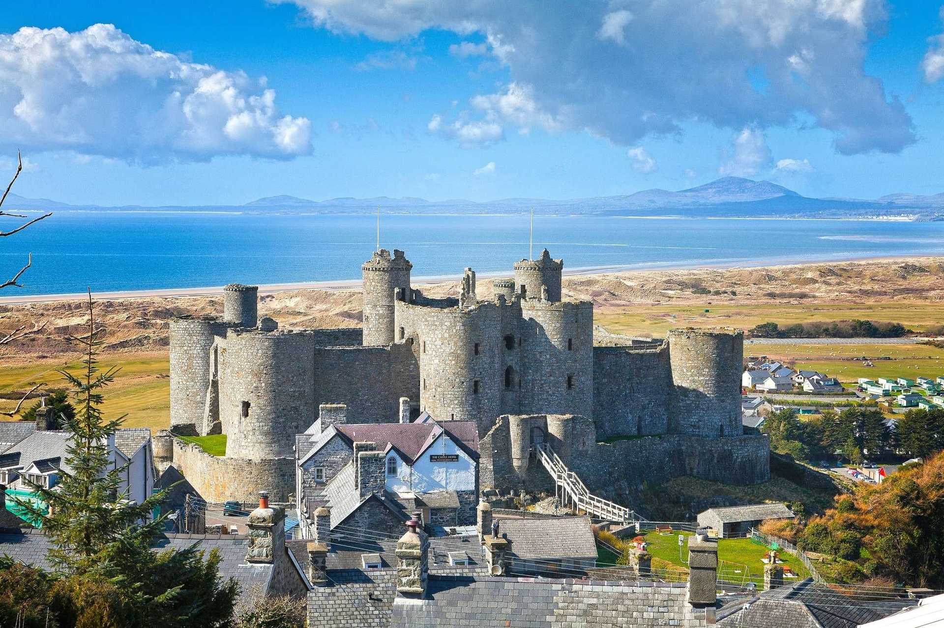Ariel vew of Harlech castle, town and beach backdrop of the mountains in Snowdonia