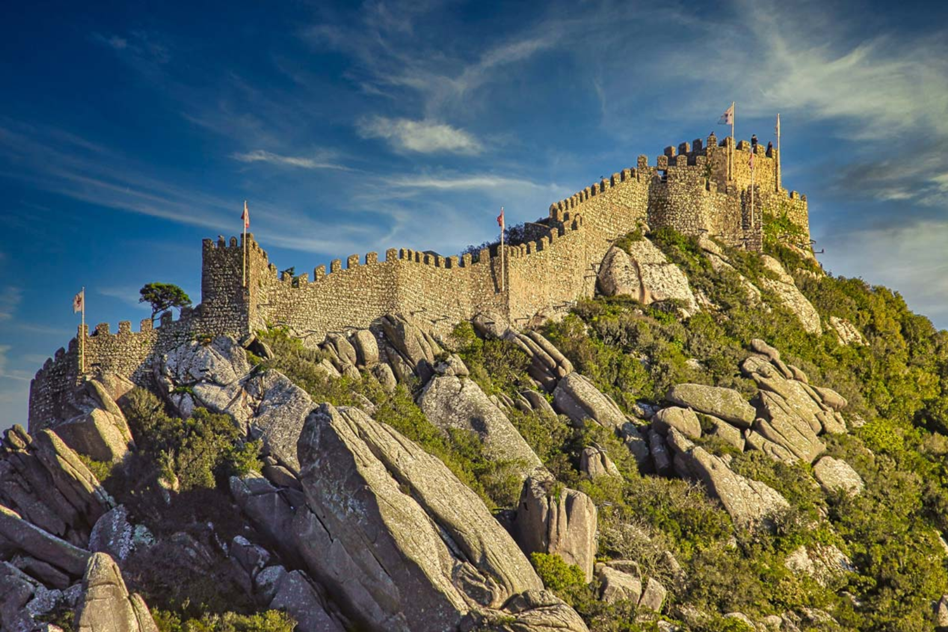 Moorish Castle battlements following a rocky hilltop above Sintra, Portugal.