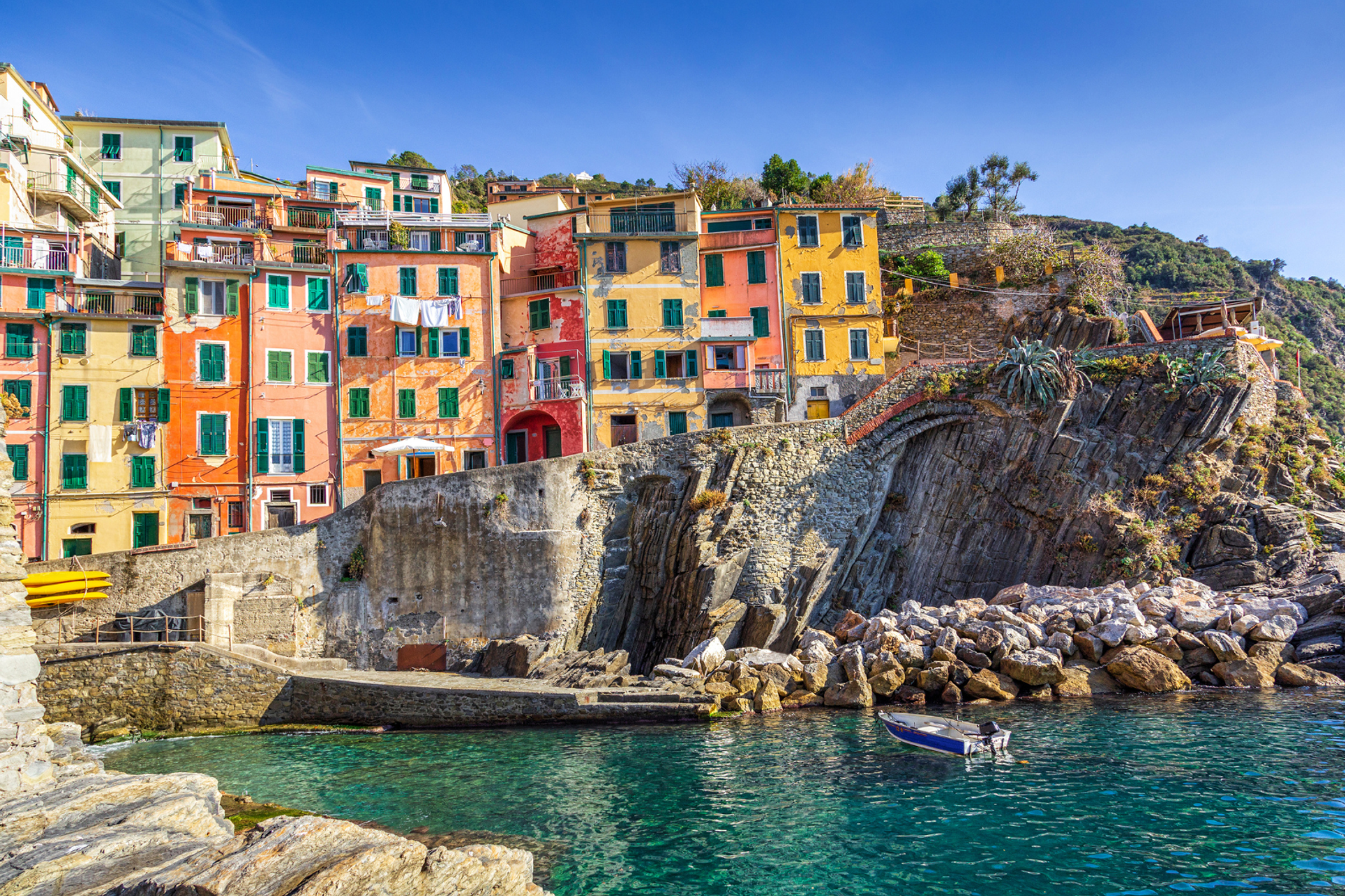 Colourful houses rising above the rocky harbour at Riomaggiore.