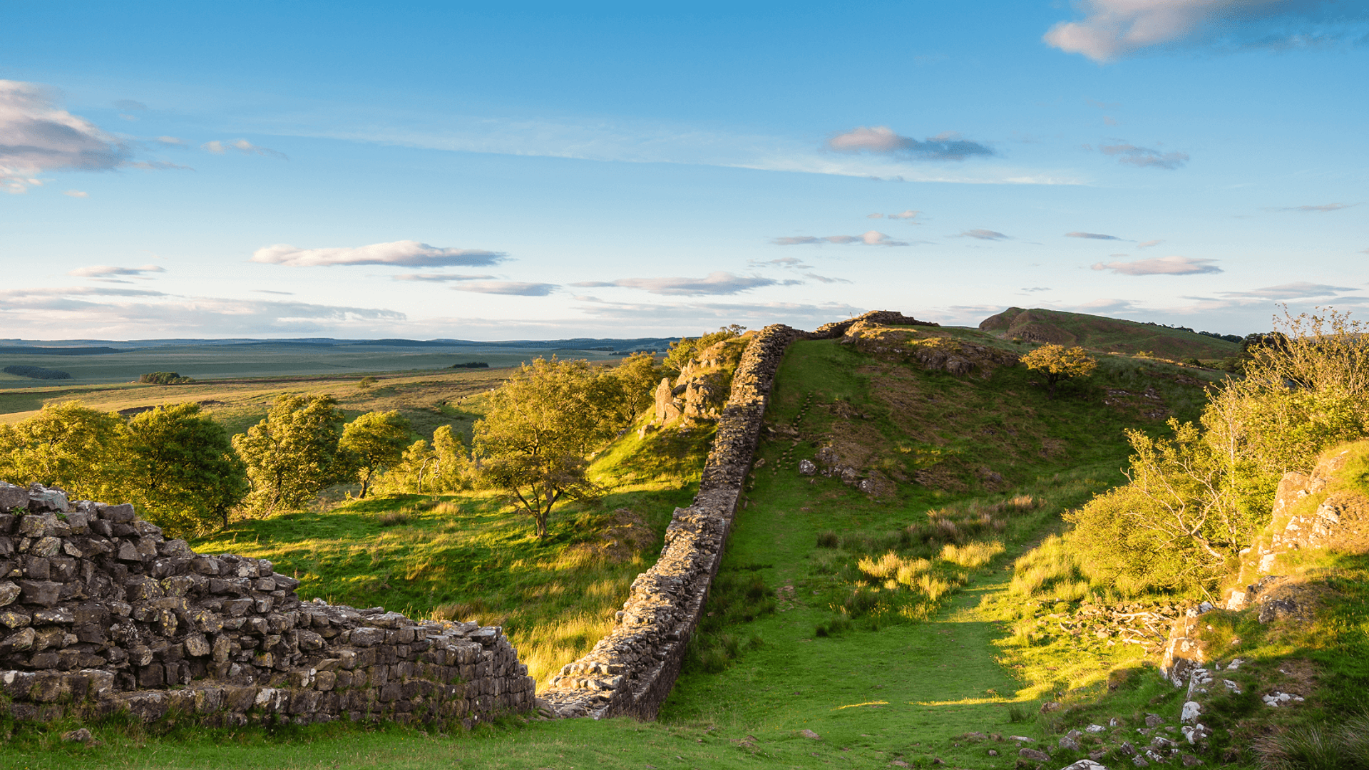 Hadrian’s Wall Path on a grassy escarpment in Northumberland National Park