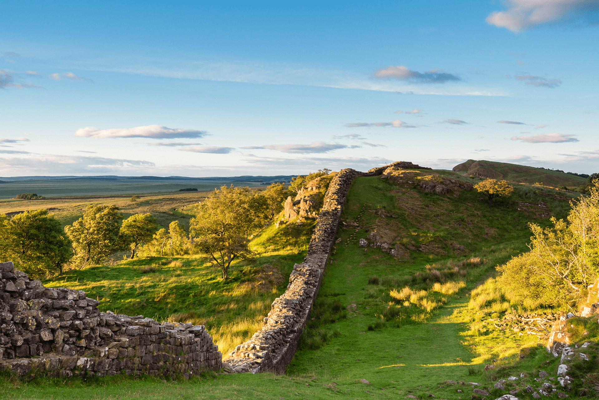Hadrian’s Wall Path on a grassy escarpment in Northumberland National Park