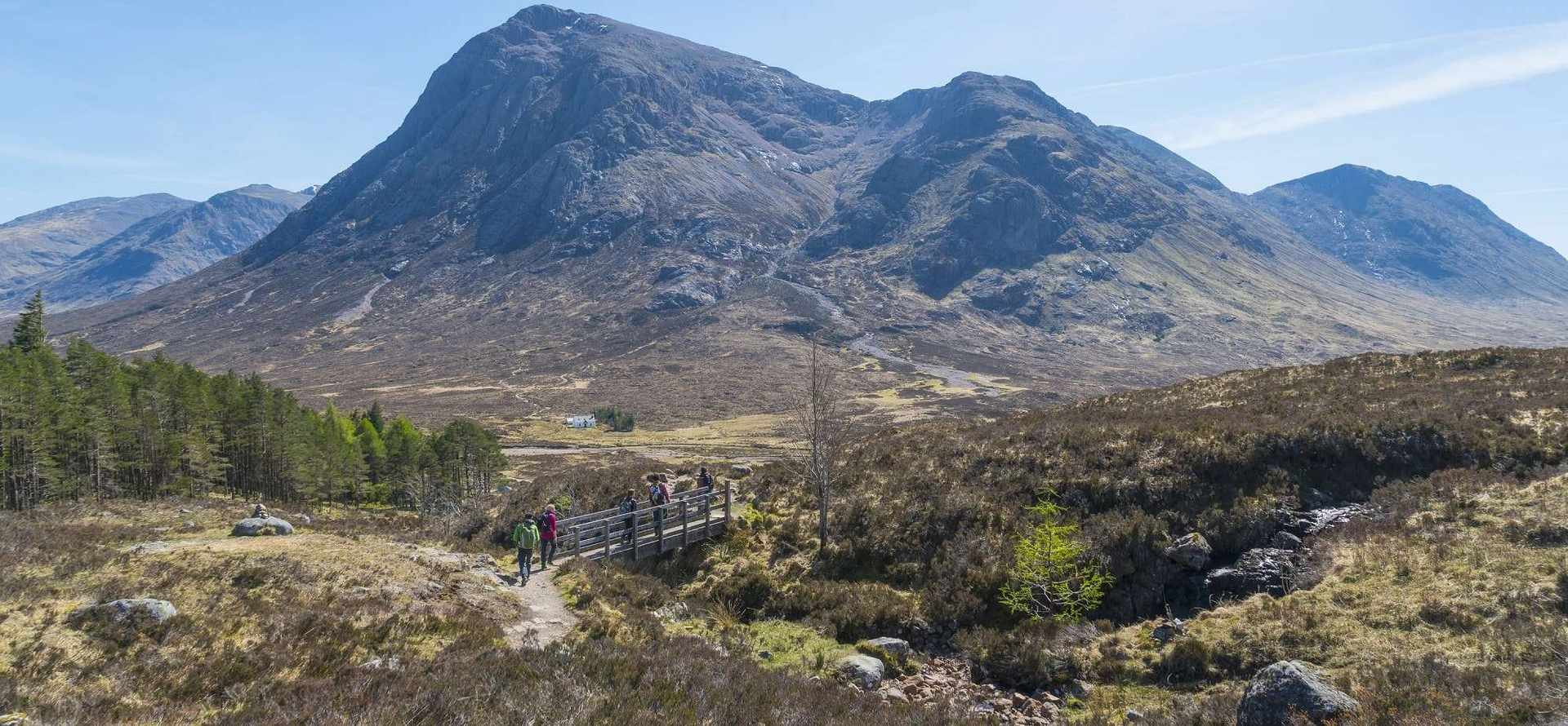 Hillwalkers on the West Highland Way passing Buachaille Etive Mor in Glencoe