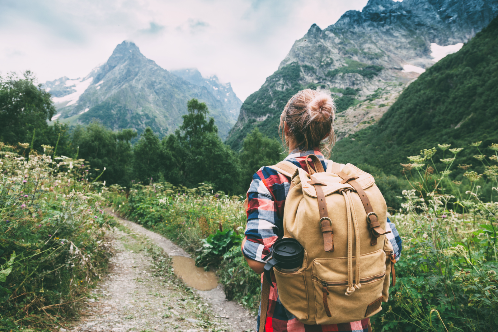 Hiker Walking to Mountains with backpack