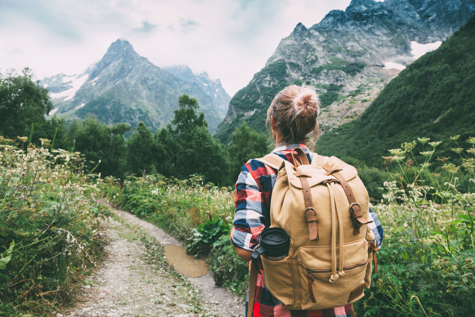 Hiker Walking to Mountains with backpack