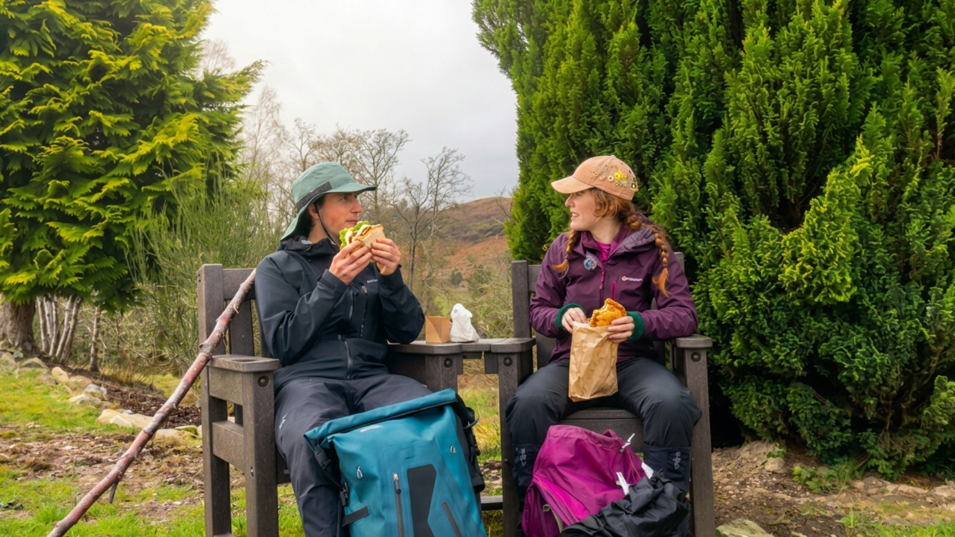 Two walkers eating a packed lunch on a bench during a self-guided walking holiday