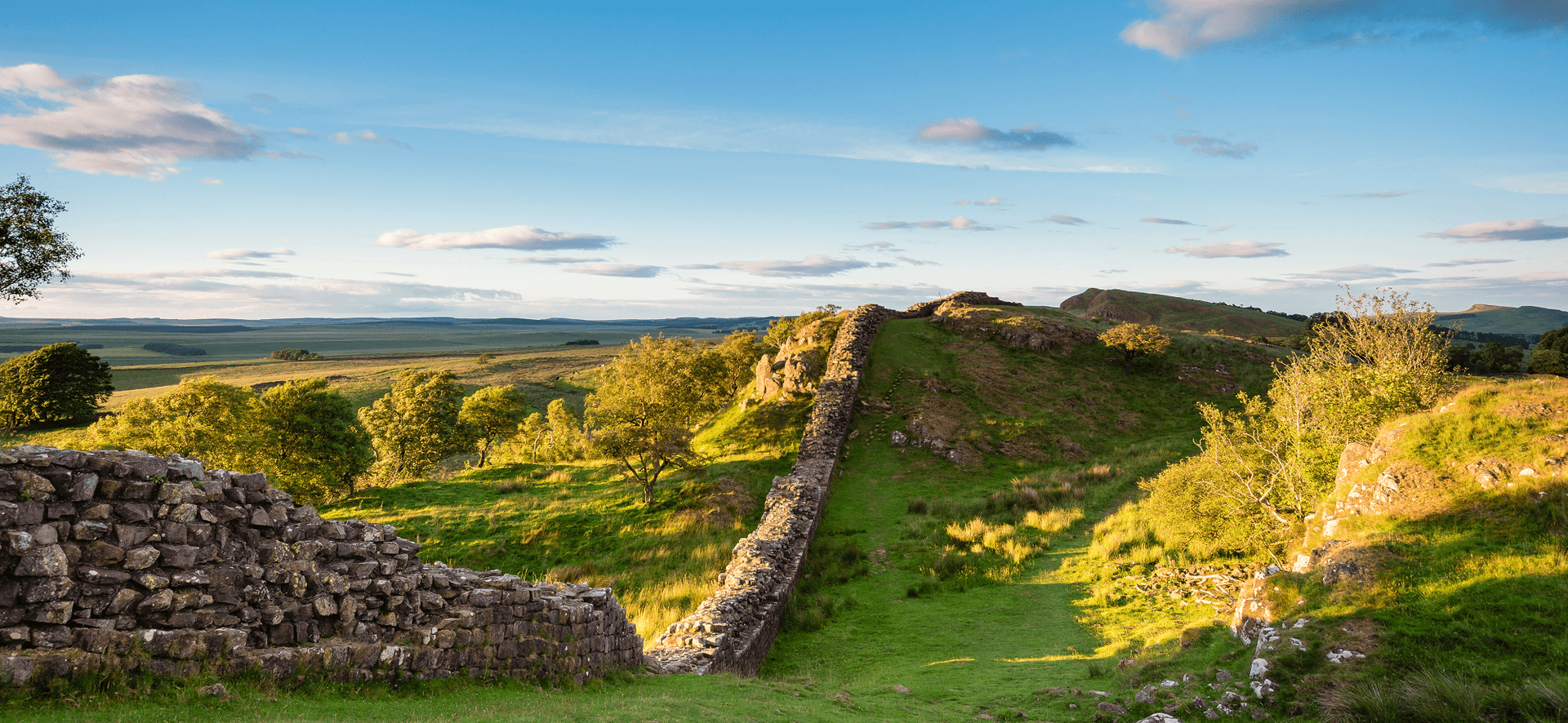 Hadrian’s Wall Path on a grassy escarpment in Northumberland National Park