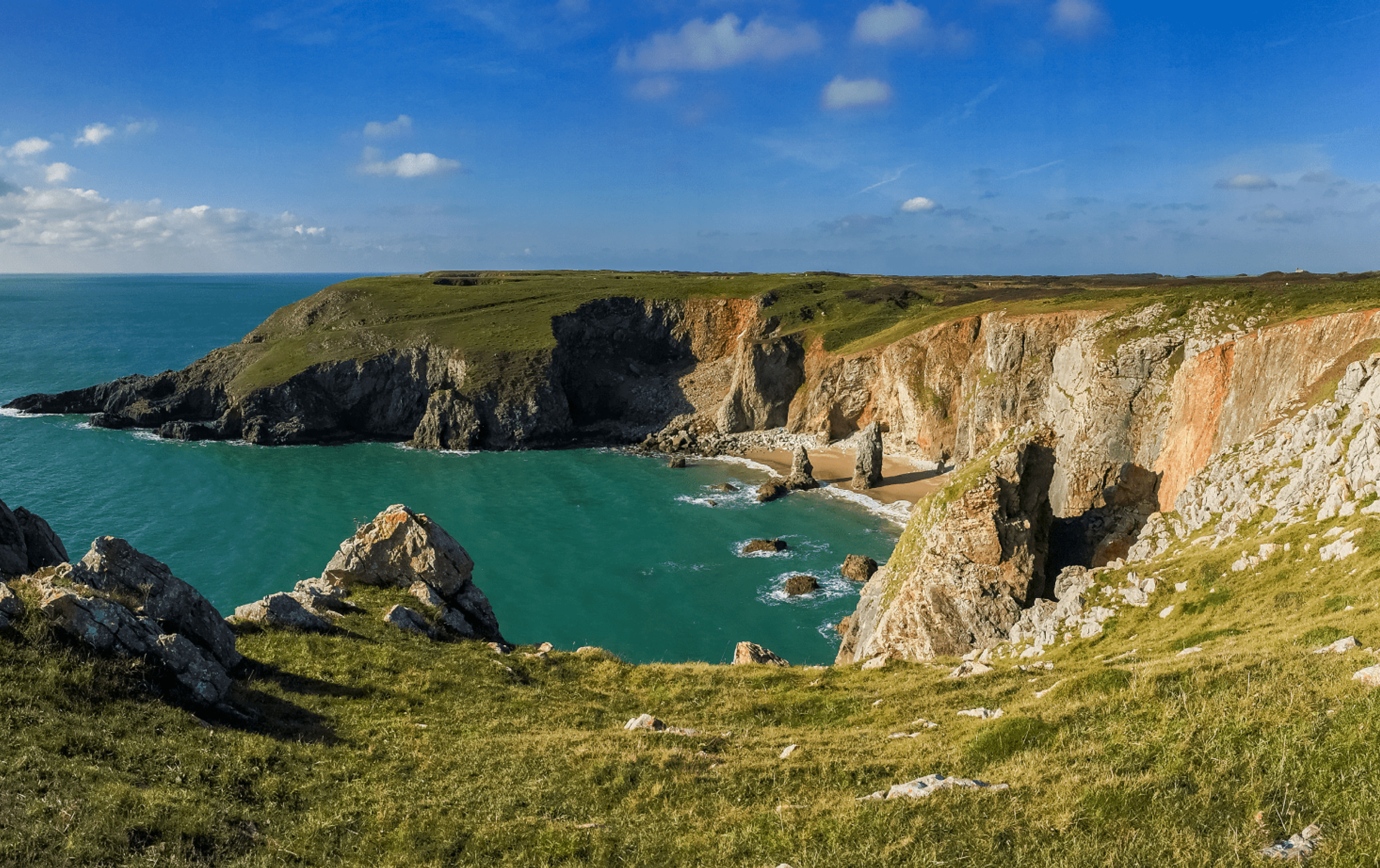 Flimstone Bay on the Pembrokeshire Coast Path, with cliffs and sea.
