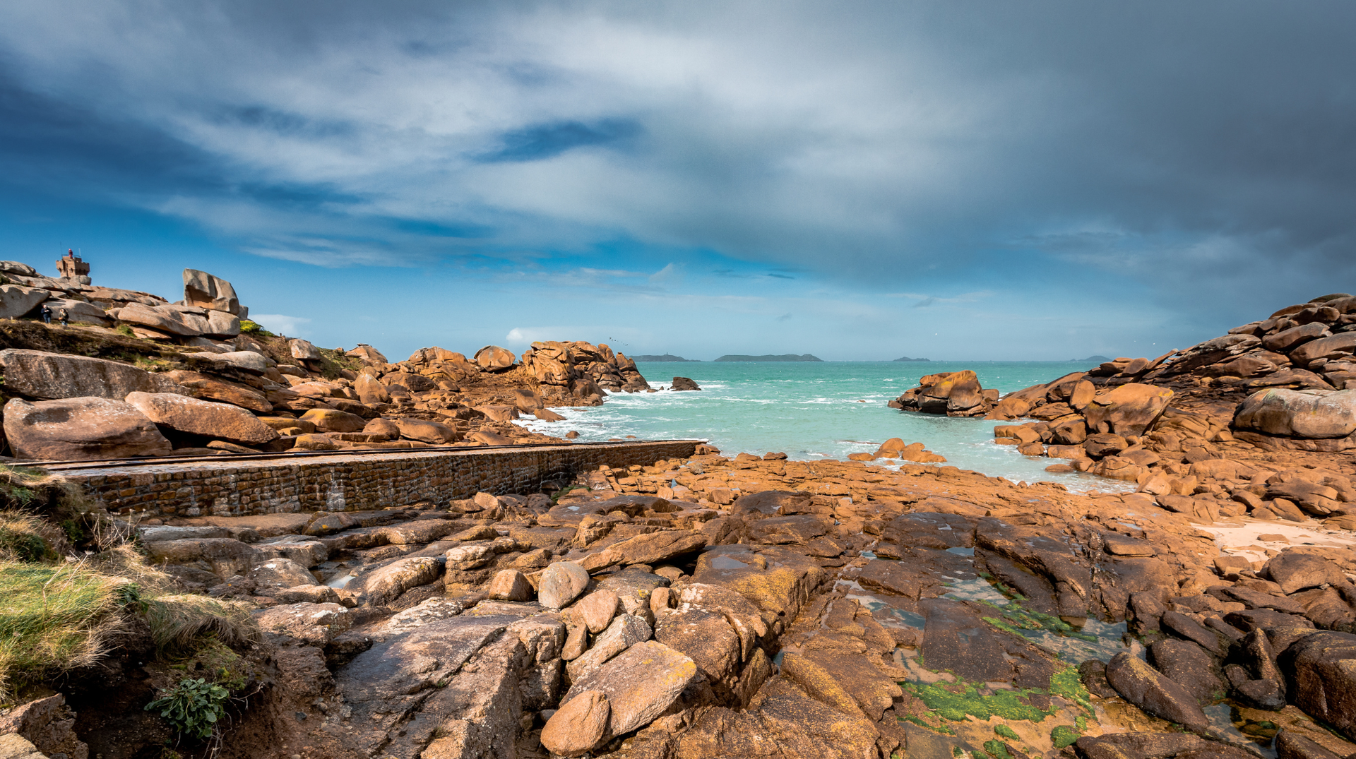 Pink granite rock formations beside the sea on Brittany’s Côtes d’Armor coast.