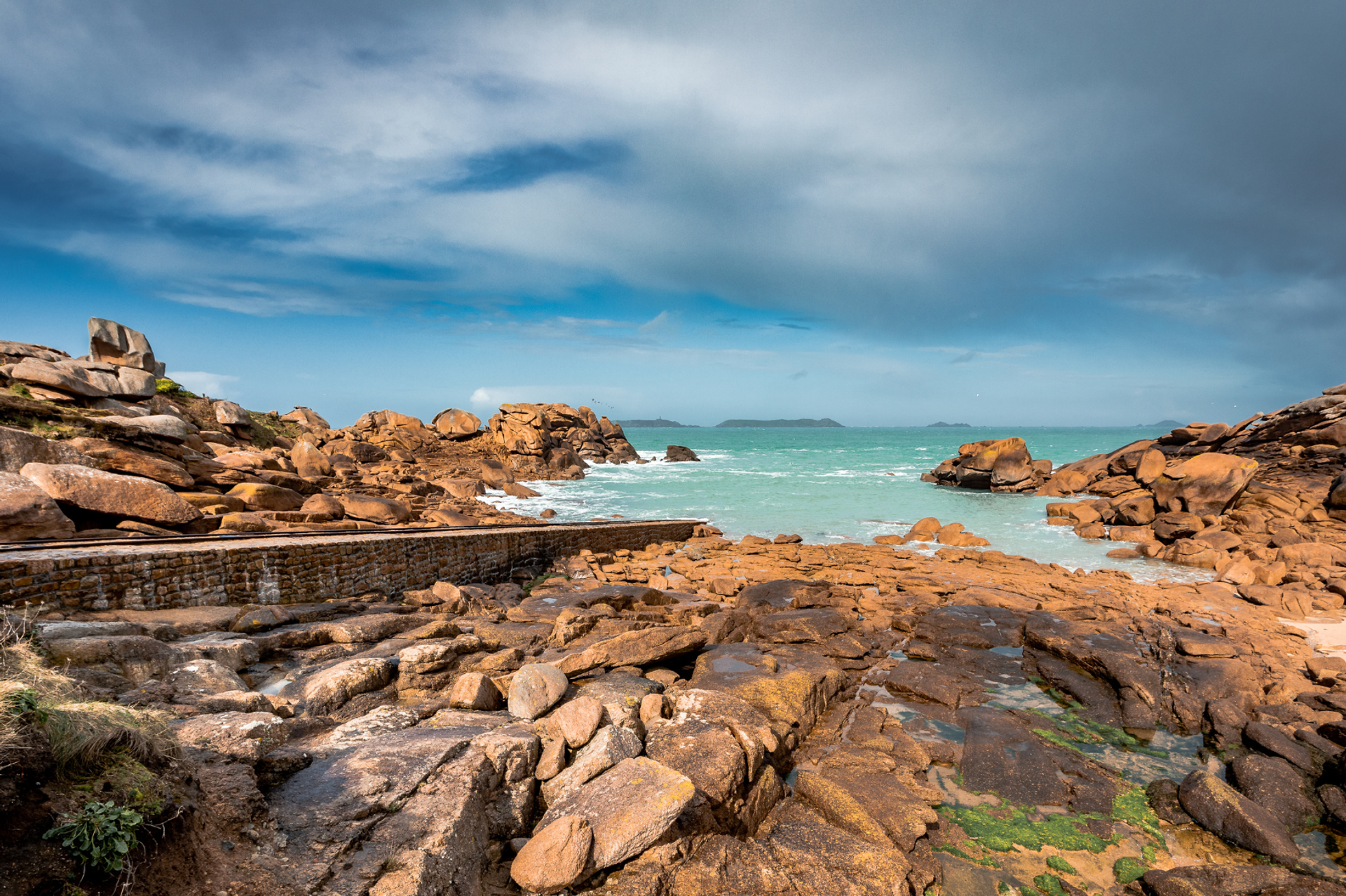 Pink granite rock formations beside the sea on Brittany’s Côtes d’Armor coast.