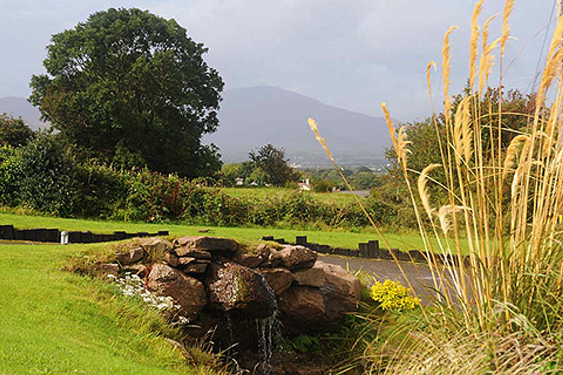 View from a standard accommodation on Dingle Way, looking out towards mountains.