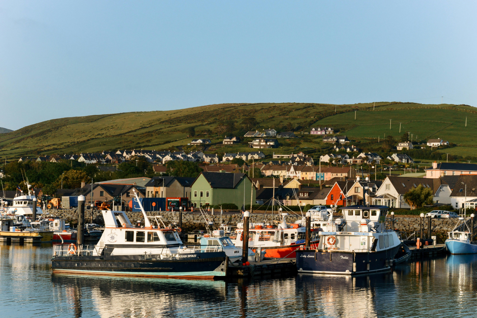 Fishing boats and colourful waterfront buildings at Dingle Harbour.