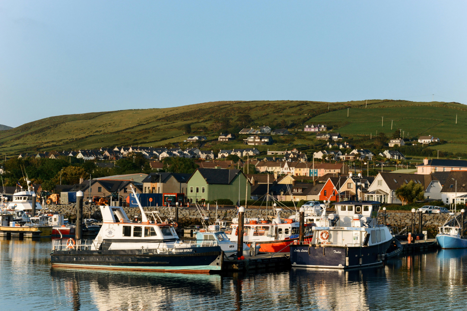 Fishing boats and colourful waterfront buildings at Dingle Harbour.