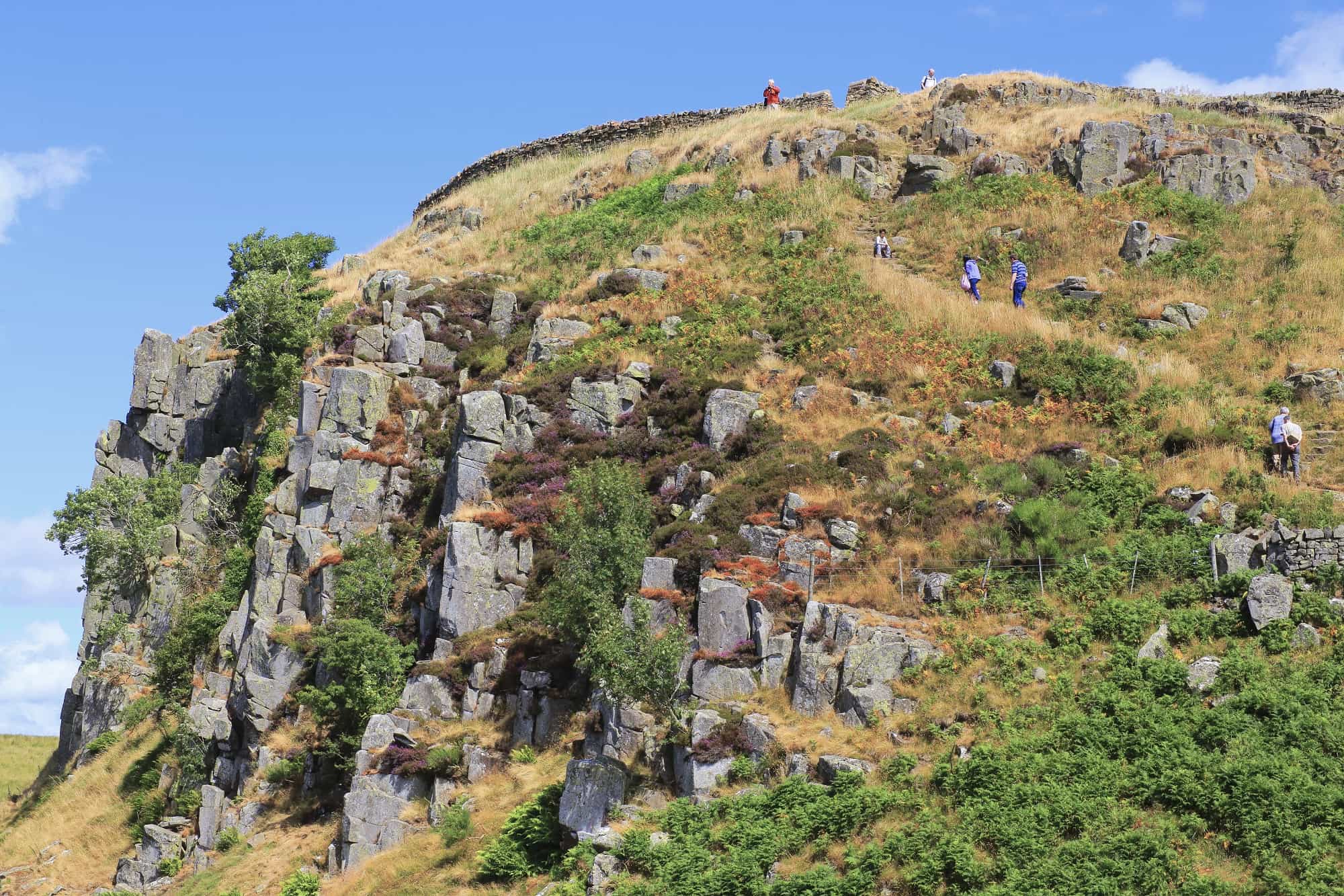 Walkers climbing the dramatic Whin Sill escarpment along Hadrian’s Wall, the volcanic ridge that formed a natural defensive barrier for the Romans.