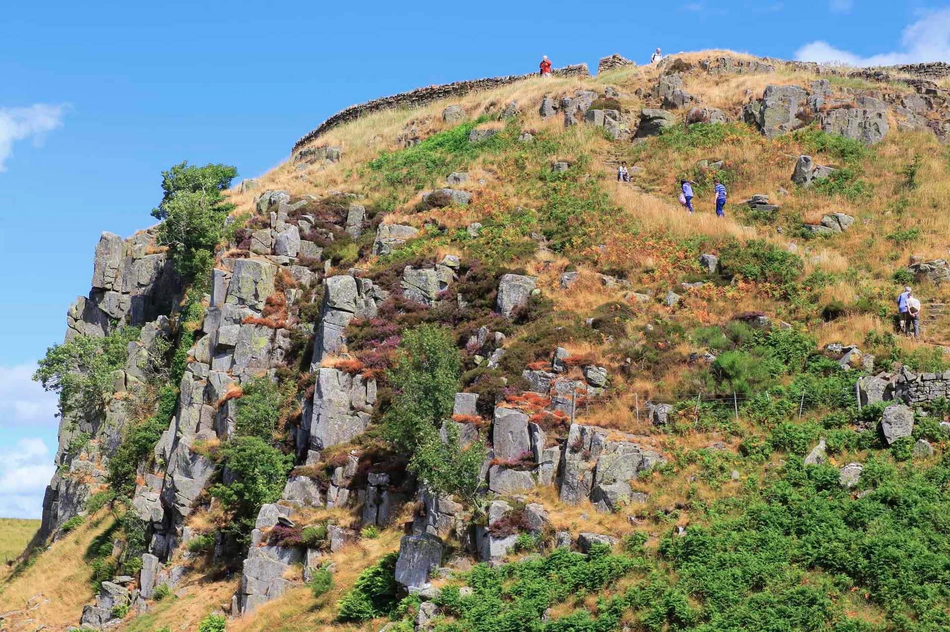 Walkers climbing the dramatic Whin Sill escarpment along Hadrian’s Wall, the volcanic ridge that formed a natural defensive barrier for the Romans.