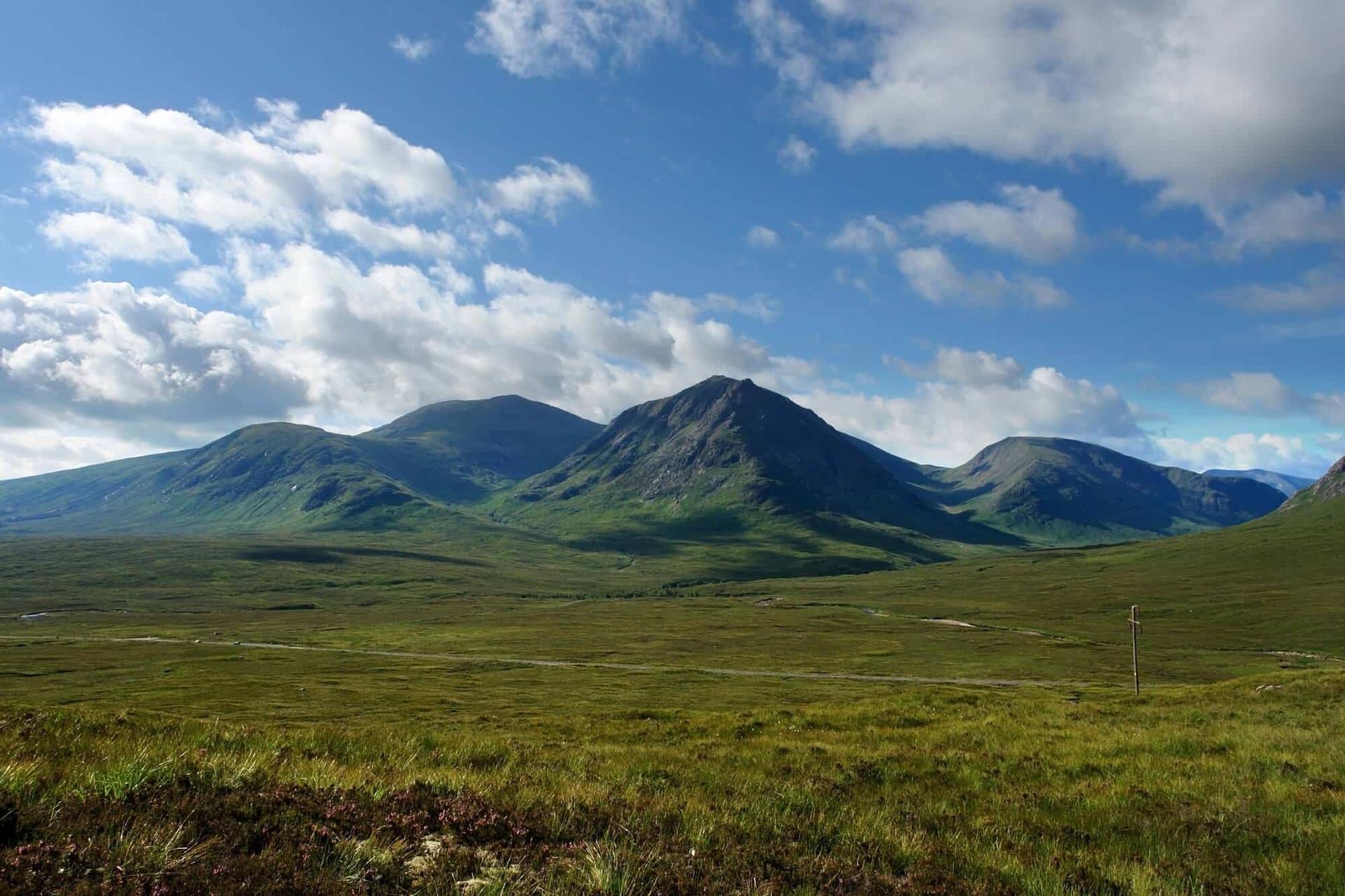 West Highland Way crossing open moorland beneath Highland mountains