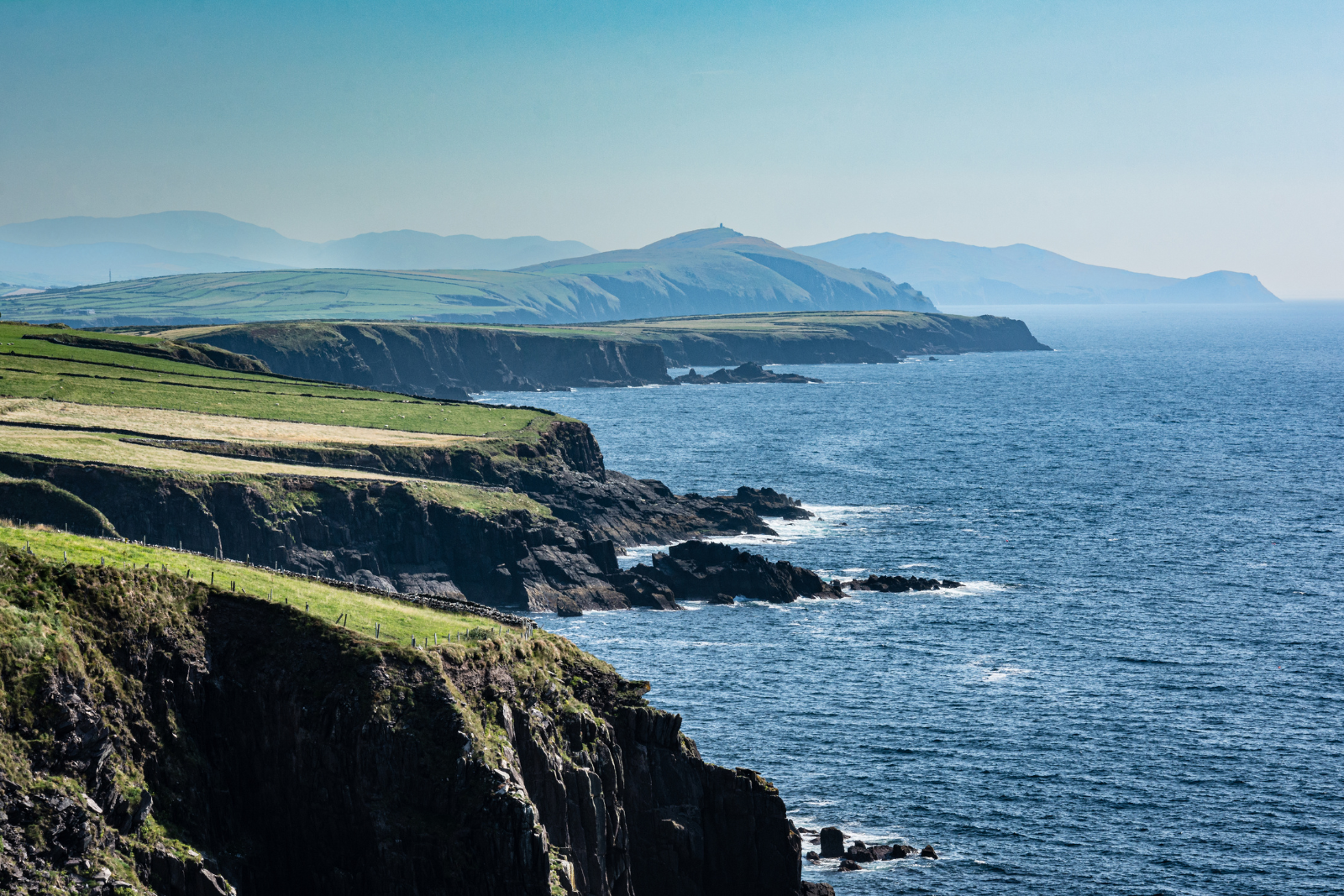 Rugged green cliffs and headlands along the Atlantic coast of the Dingle Peninsula