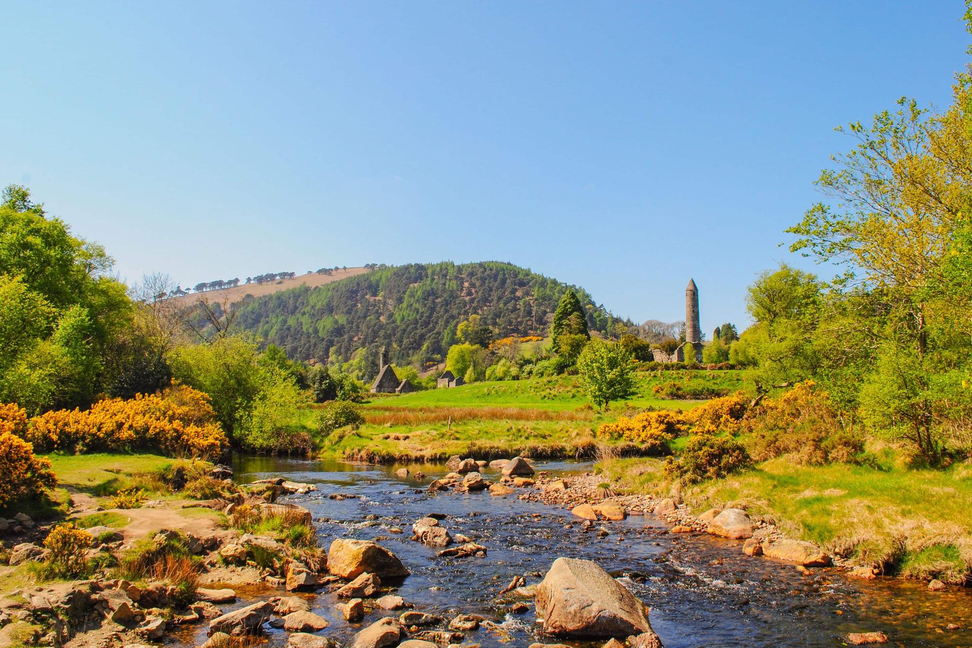 Round tower at Glendalough viewed from across the river in spring
