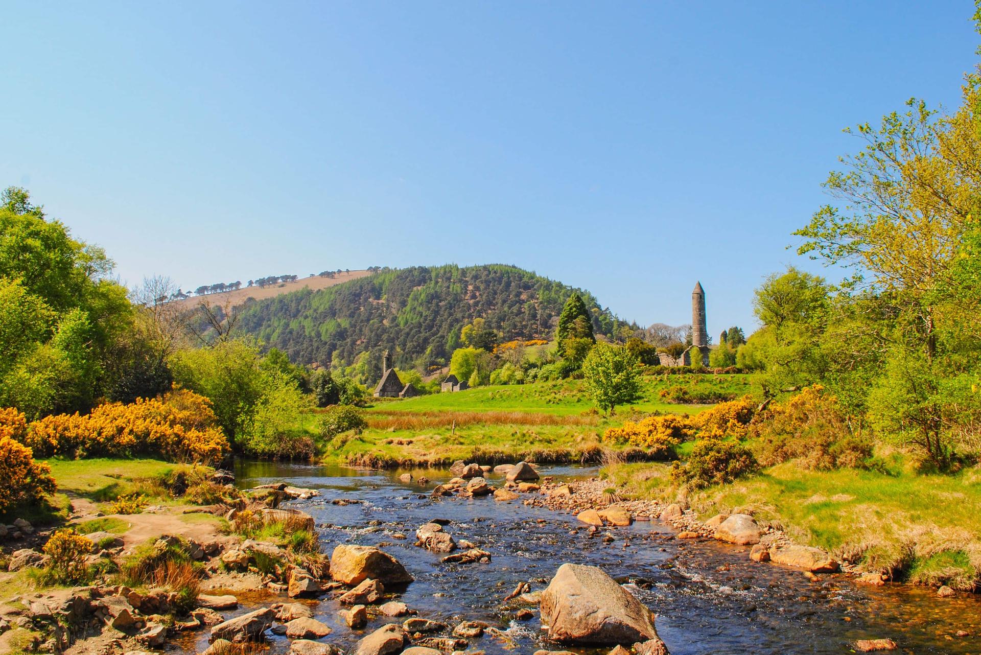 Round tower at Glendalough viewed from across the river in spring