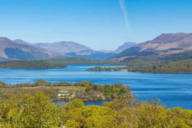 View over Loch Lomond from Conic Hill showing wooded islands and Highland hills beyond