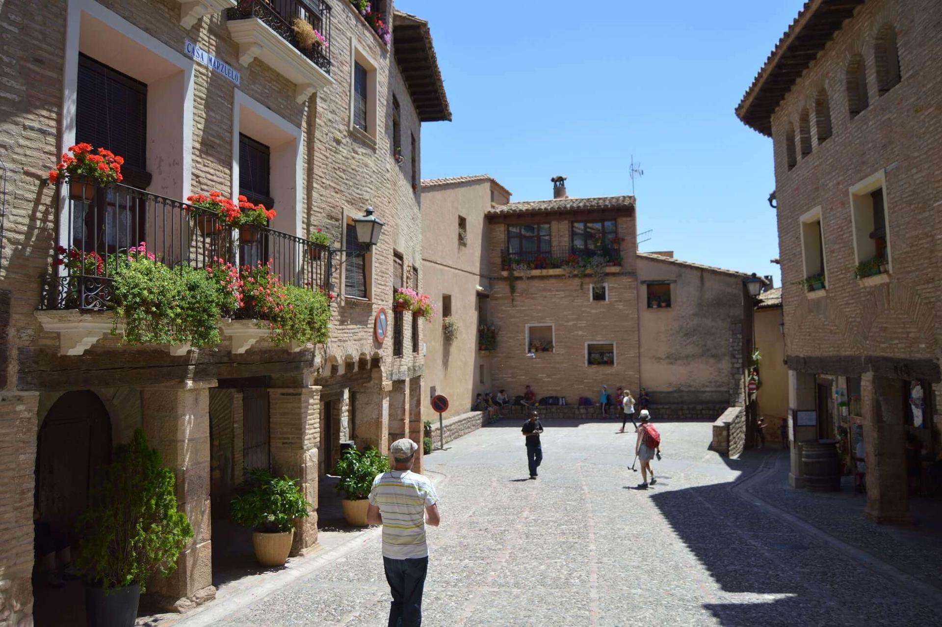 Cobbled square and stone houses in the medieval village of Alquézar, Aragon, Spain