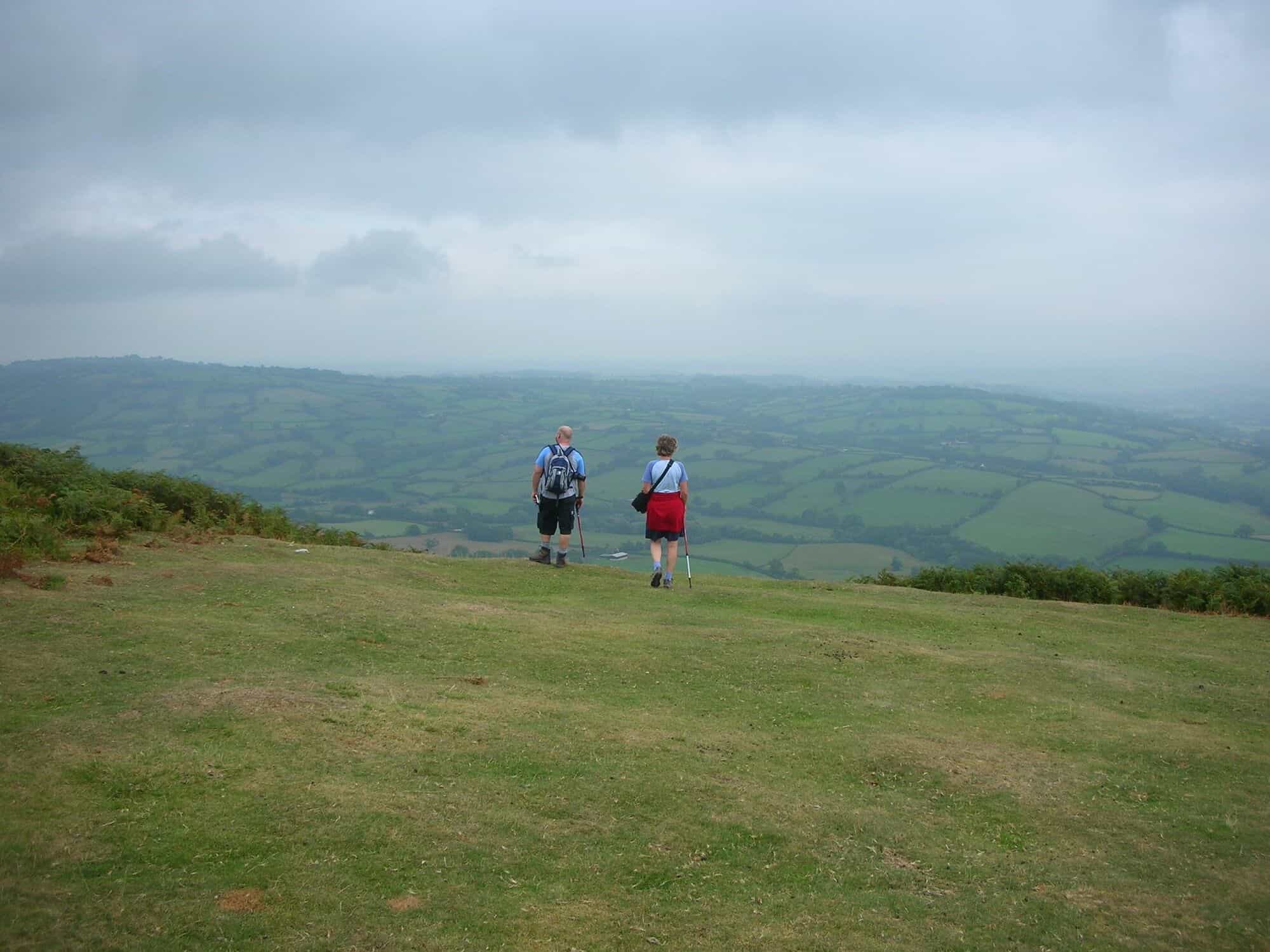 Walkers on the ridge of the Clwydian Range with views across the Welsh borders