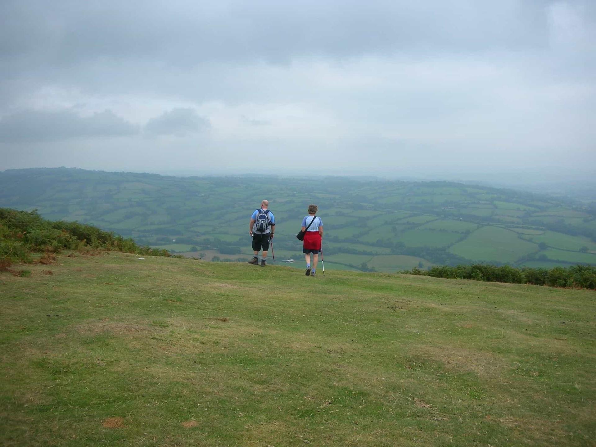 Walkers on the ridge of the Clwydian Range with views across the Welsh borders